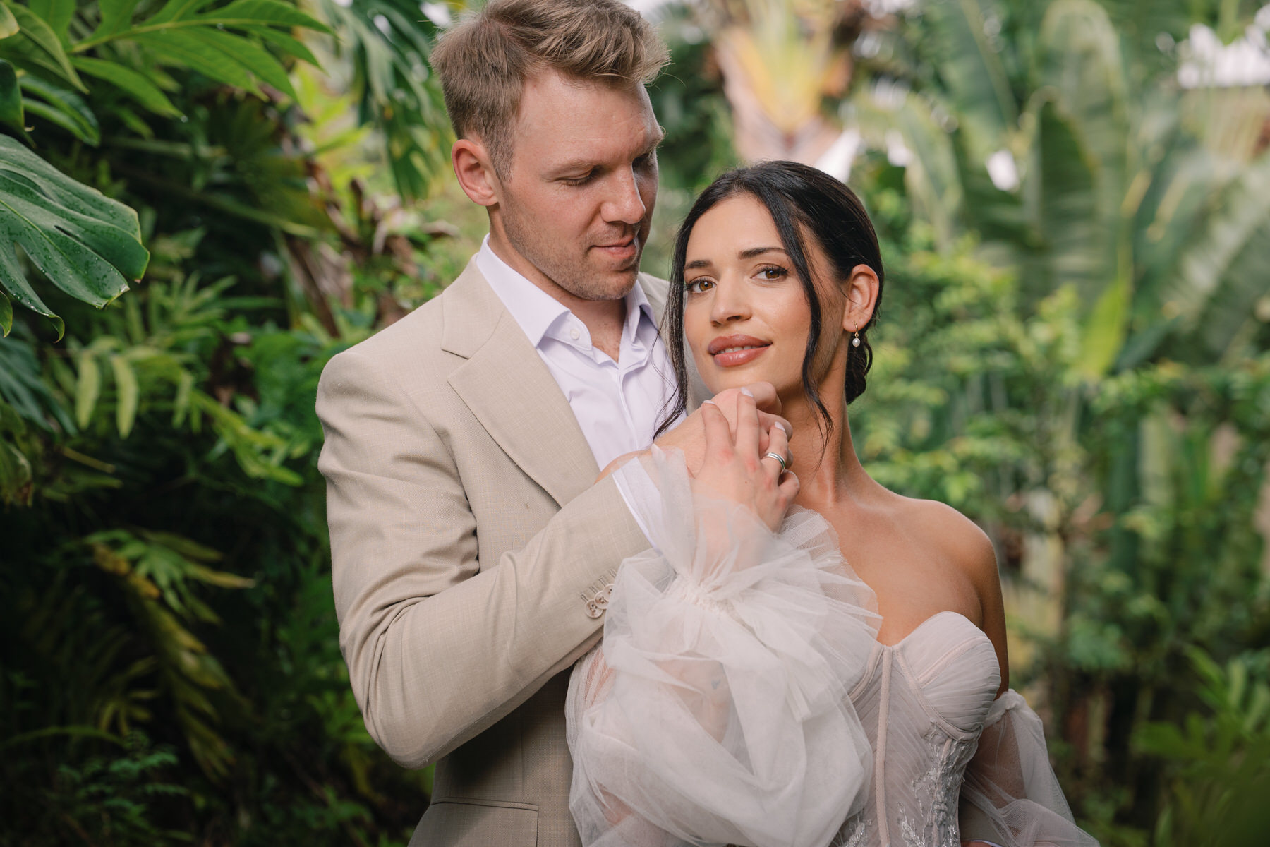 A bride and groom in the lush forest during their Kauai elopement.