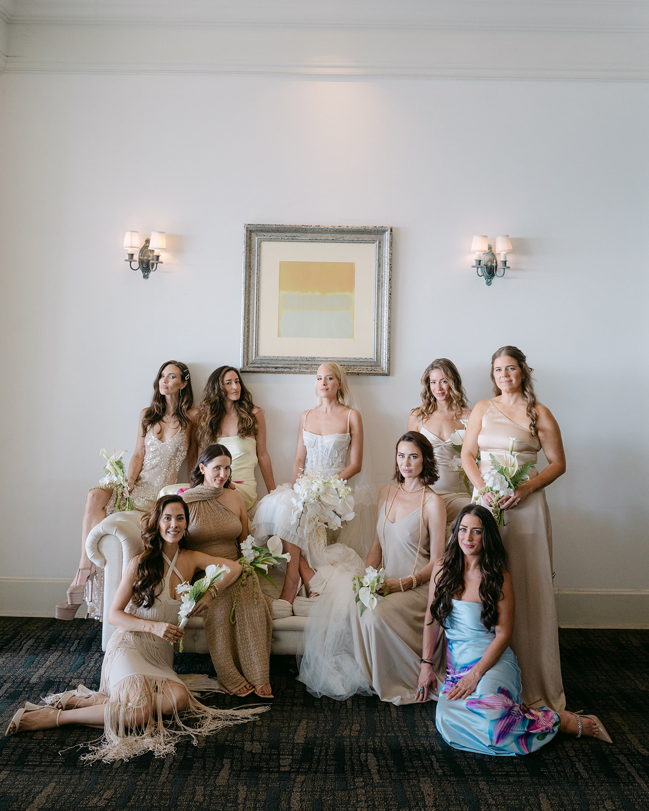 Bridal party in elegant attire posing.