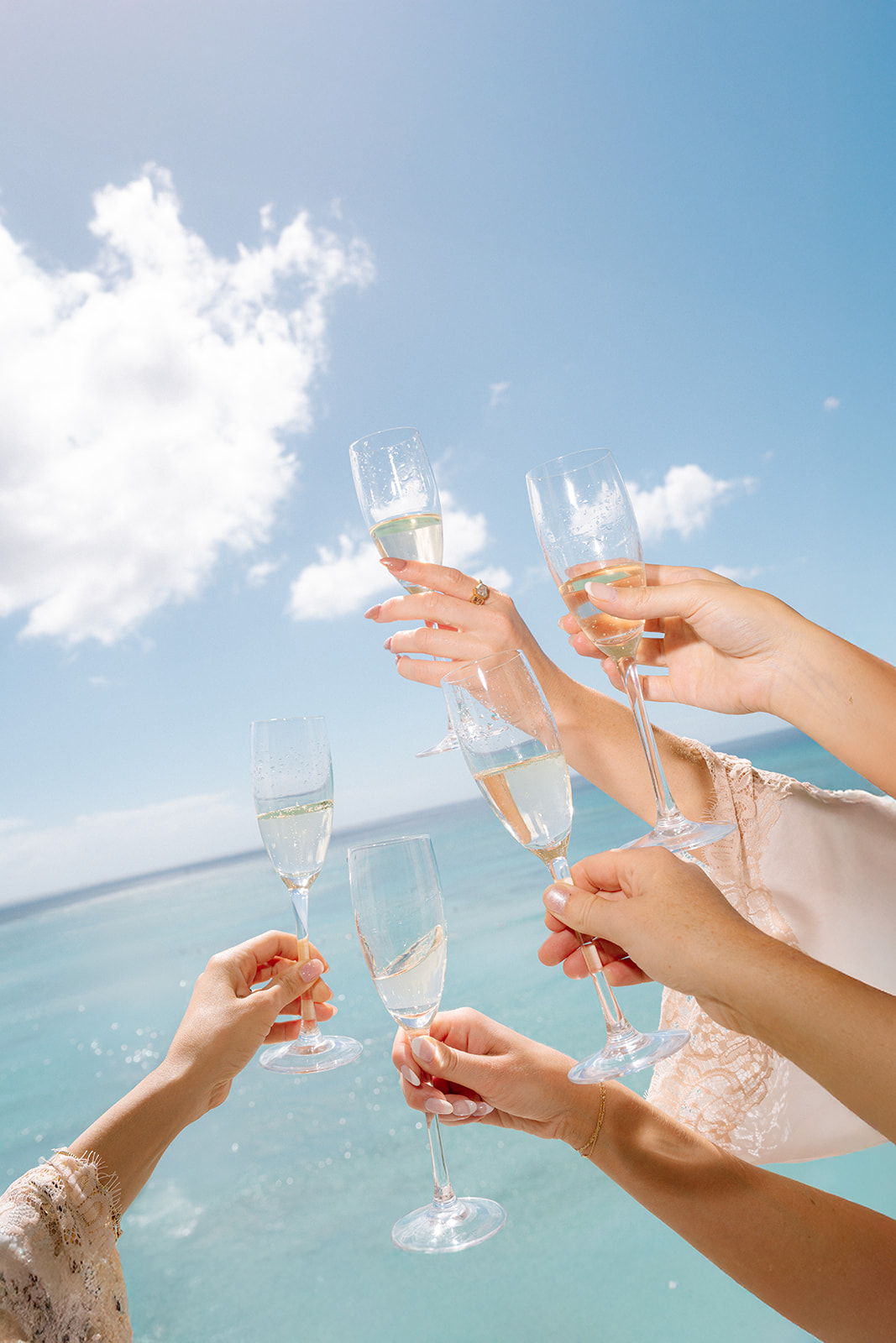 Cheers with champagne by the ocean.