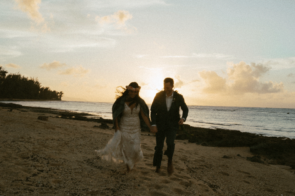 newlyweds running on the beach during sunset captured by Masha Sakhno Photo.