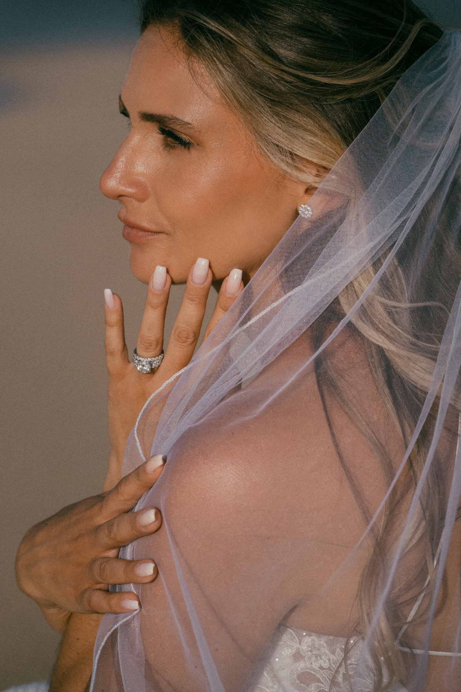 A detail shot of a bride displaying her gorgeous wedding ring from Tiffanys