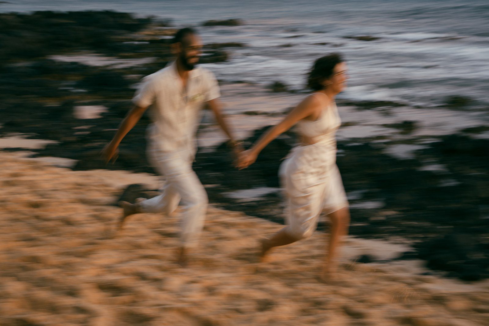 Blurry photo of newlyweds running on the beach