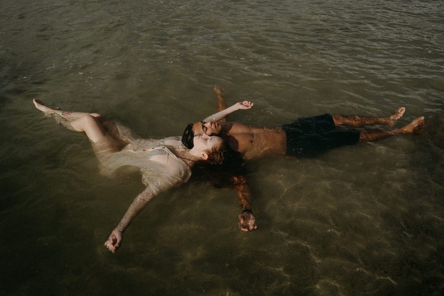 Couple in ocean during their Oahu couples session.