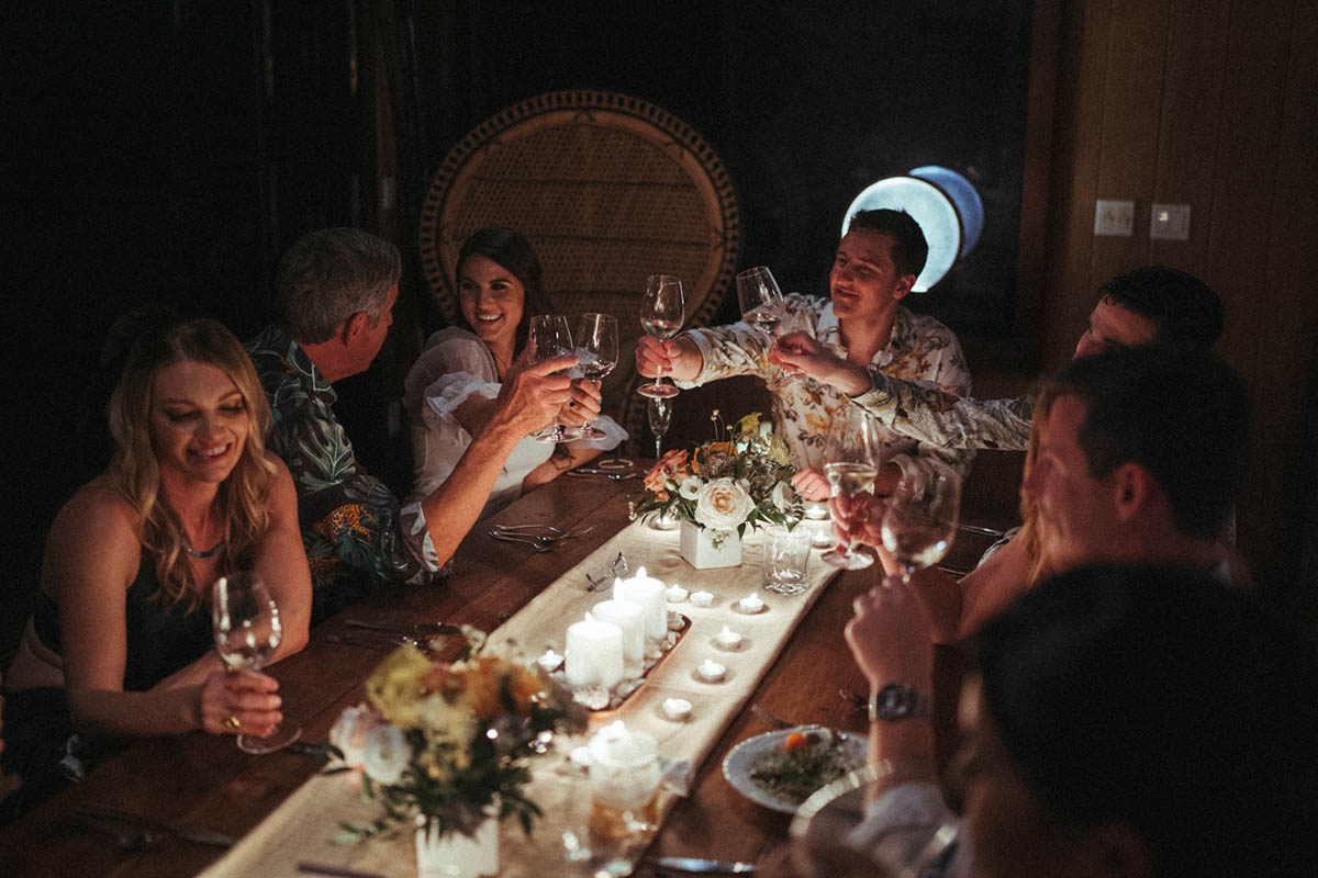 Couple and friends enjoy dinner prepared by private chef after intimate elopement.