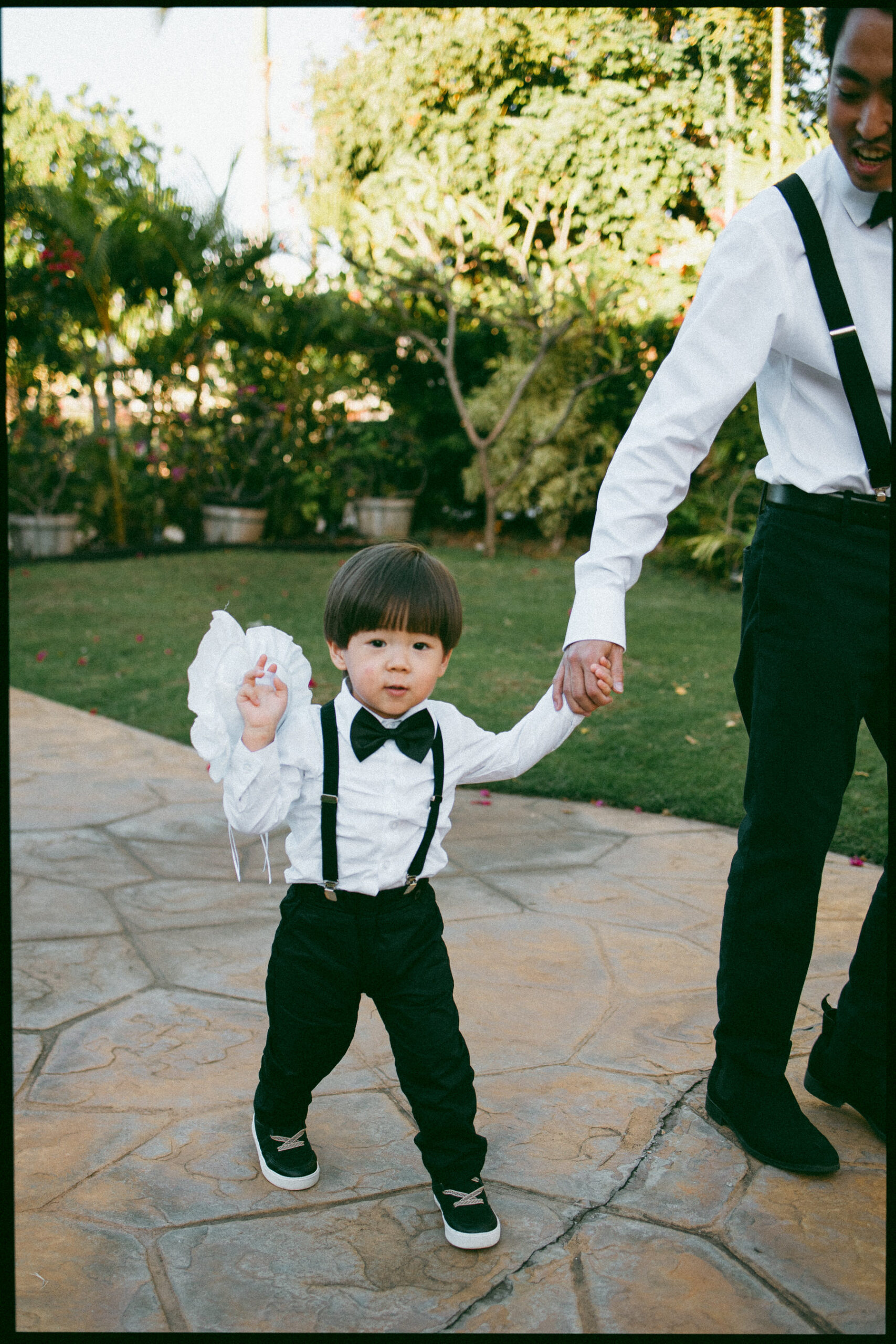 Ring bearer gets led into the church.
