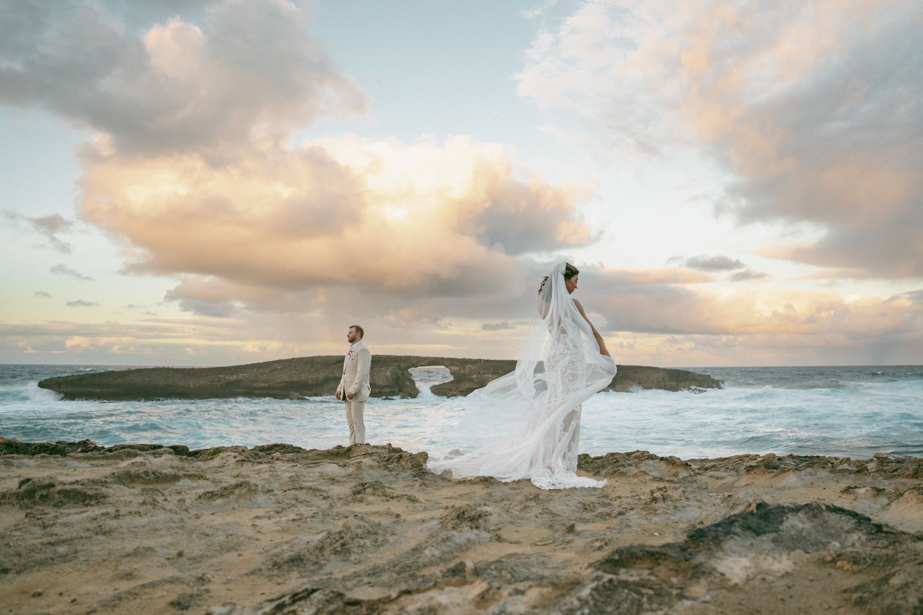 Bride and groom during sunset portraits at Laie Point.