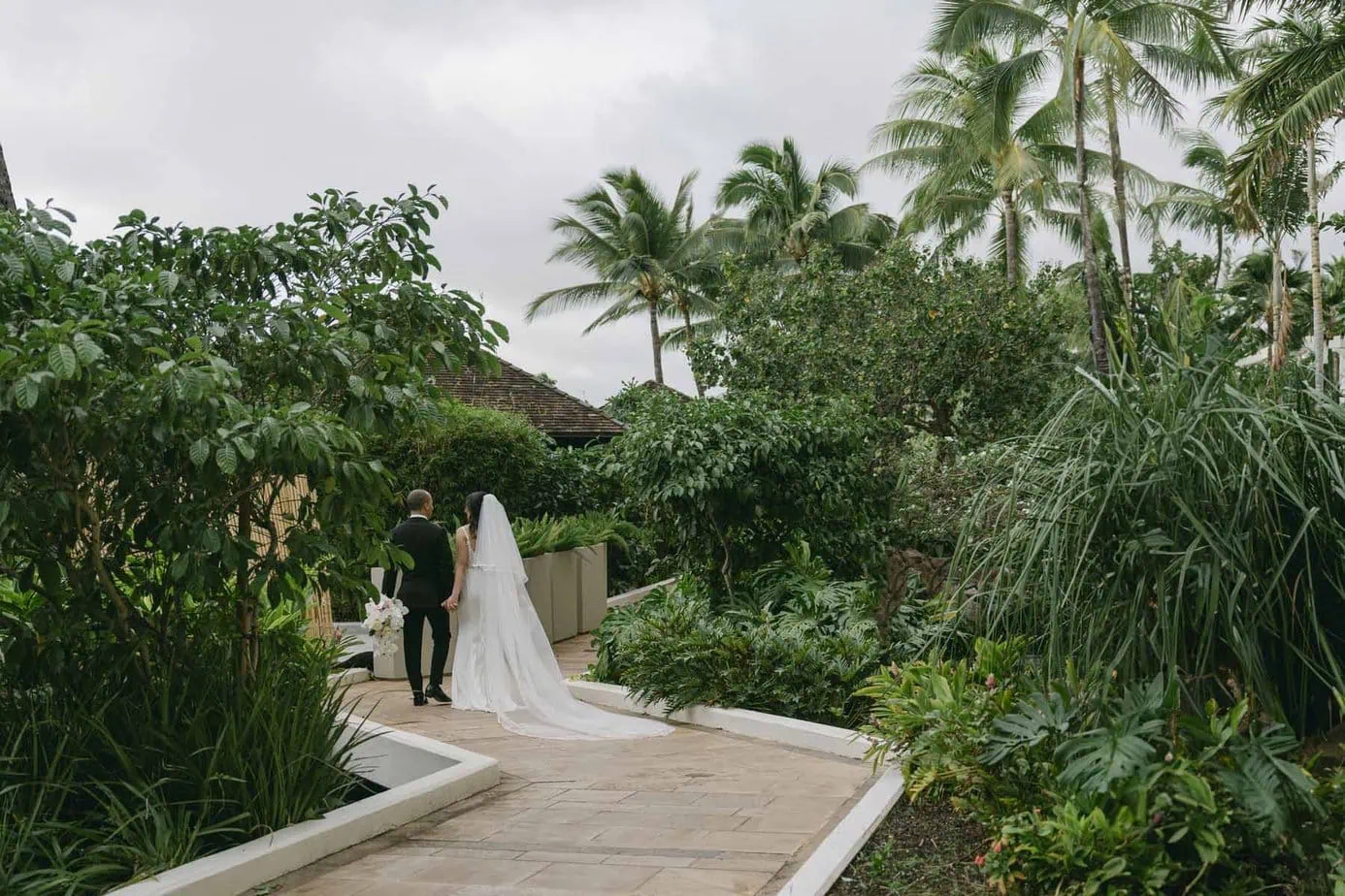 Newlyweds stroll through the gardens during their Four Seasons Ko'olina Wedding.