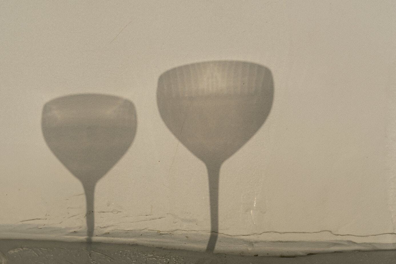 Shadow of two martini glasses.