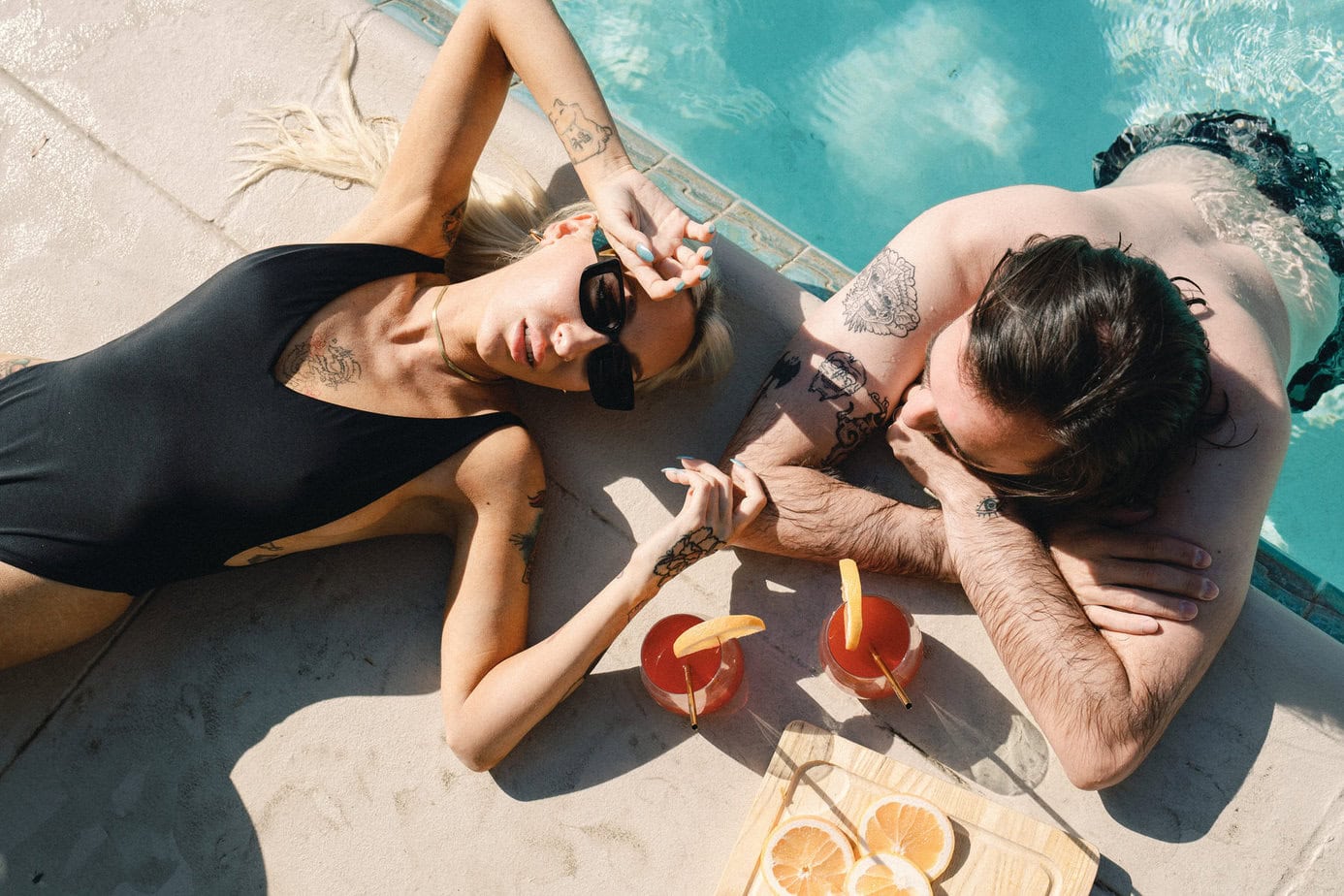 Couple lounges by pool in Palm Springs.