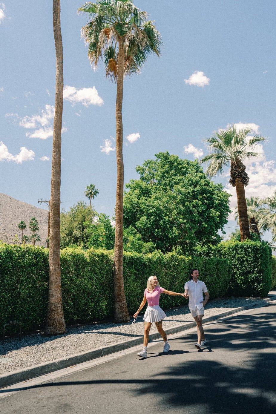 Couple runs on street in Palm Springs.