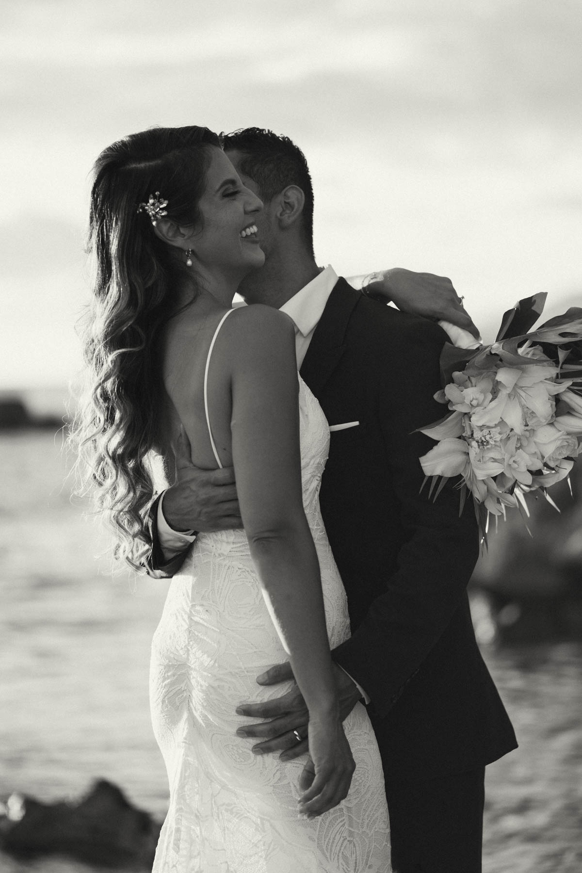 A black and white photo of bride and groom at Lanikuhonua Cultural Institute.