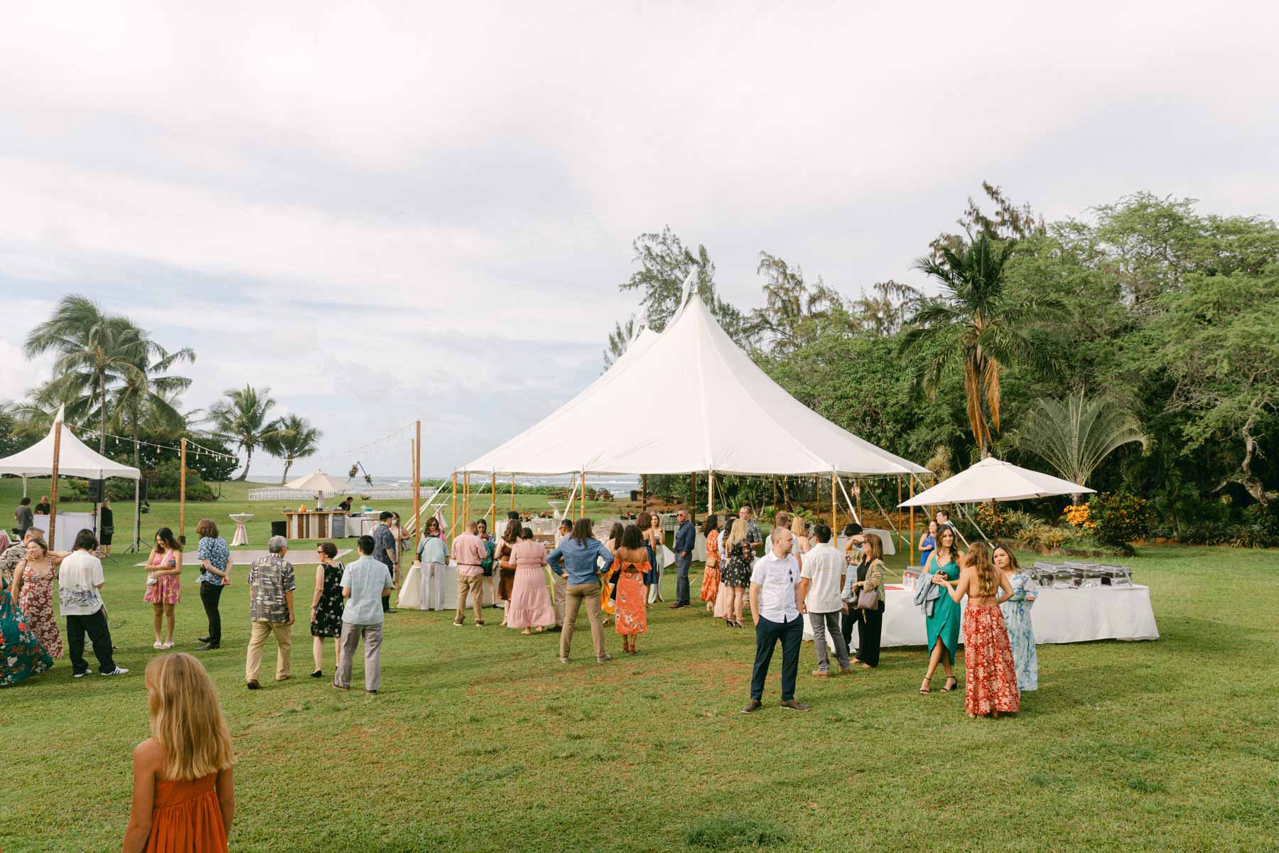 Guests enjoying cocktail hour at a wedding at Loulu Palms in Oahu.