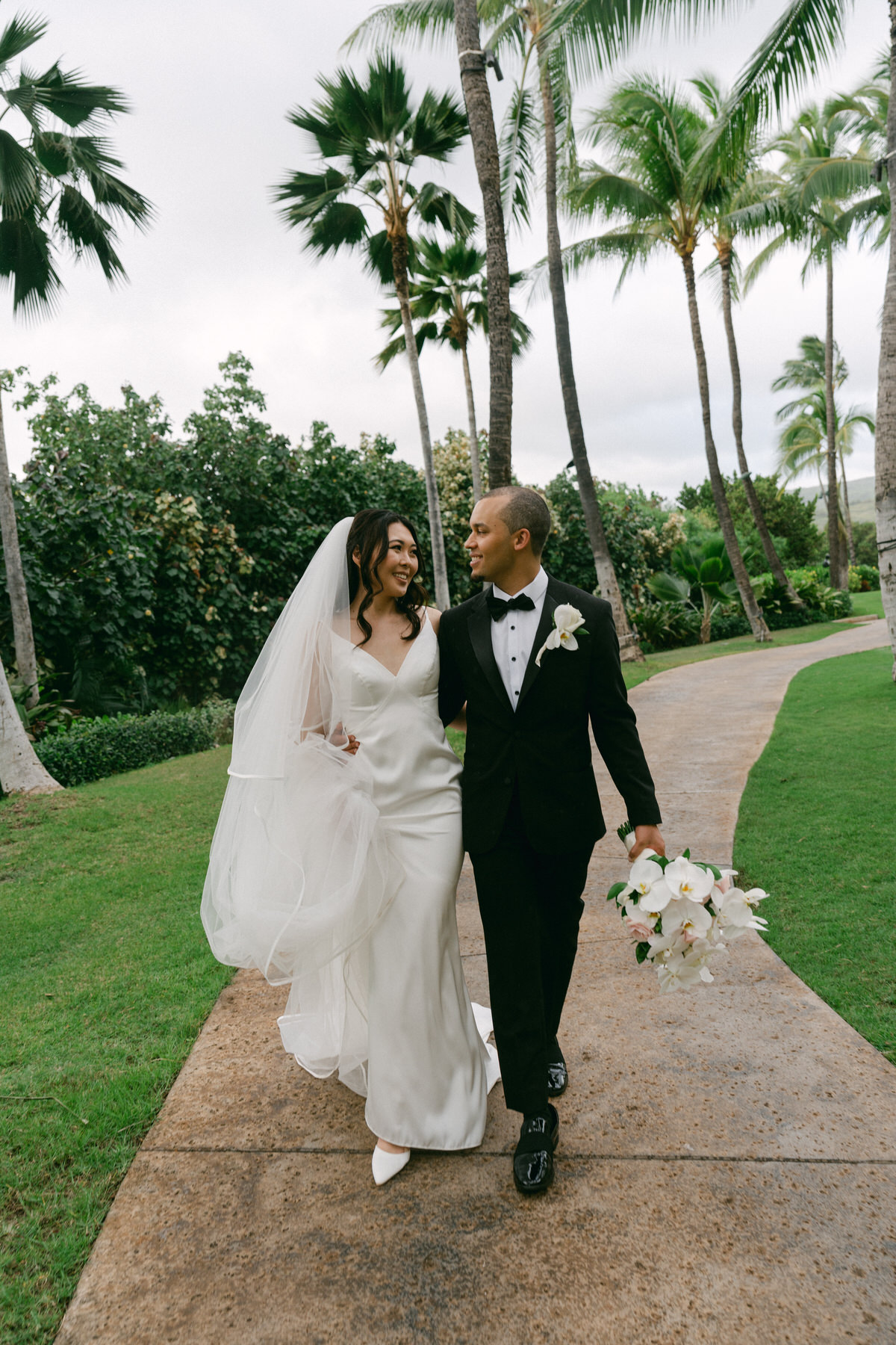 A portrait of the bride and groom at the Four Seasons, one of the best hotel Oahu wedding venues.