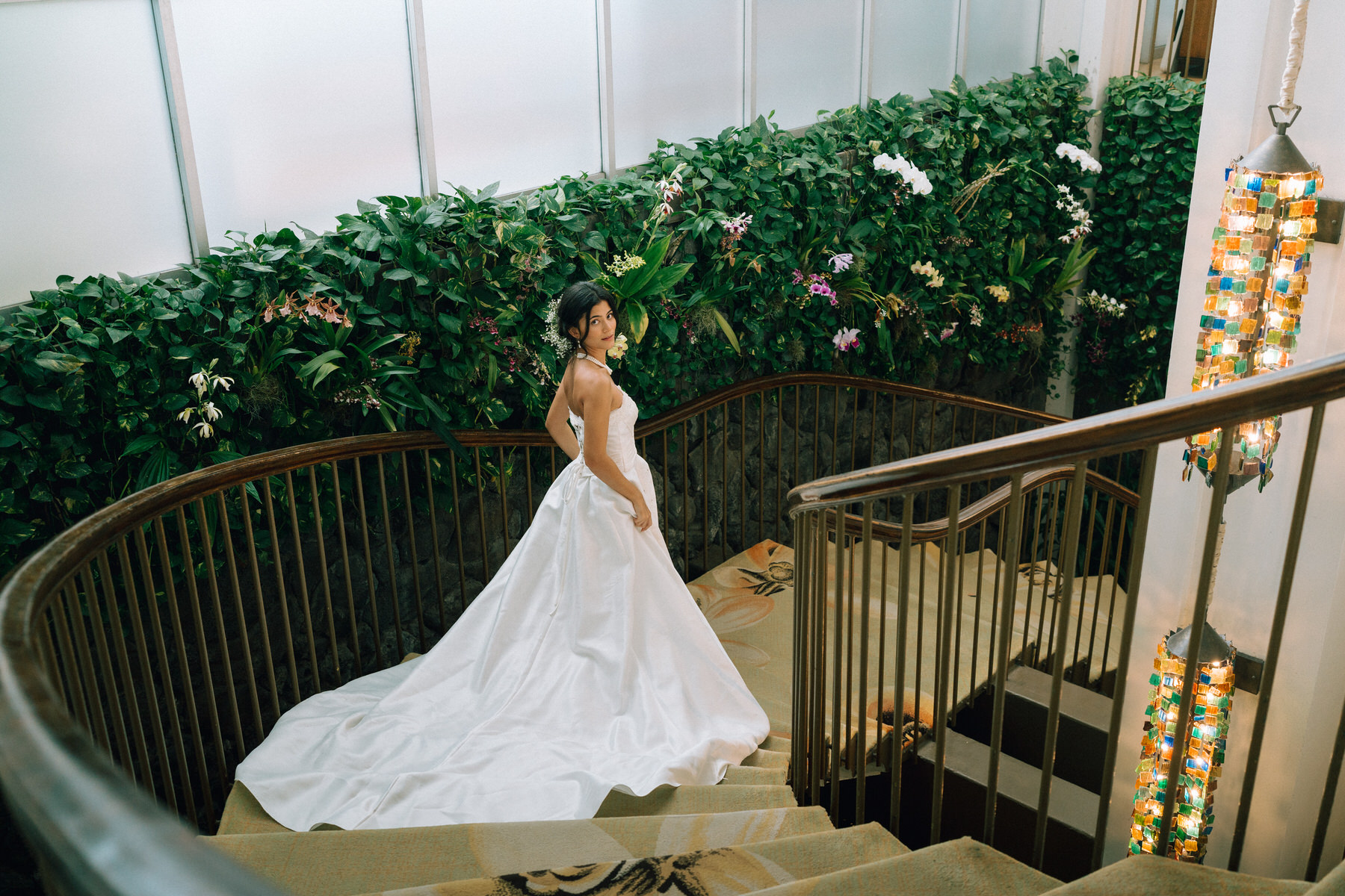 A bride goes down the stairs at the Kahala Hotel. This is one of the best wedding venue at Oahu's in Hawaii.