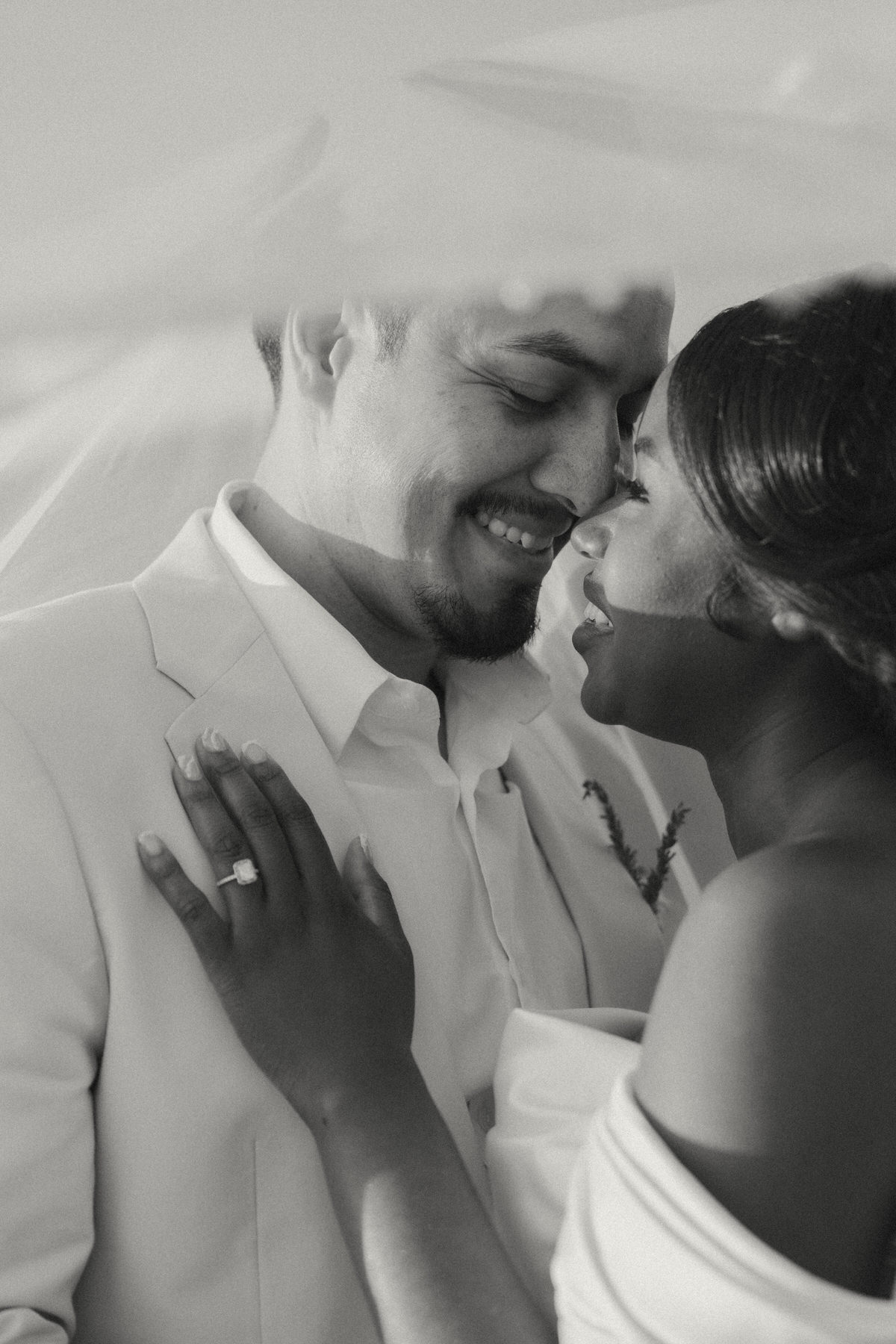 A bride and groom under veil during their Serendipity Gardens wedding.