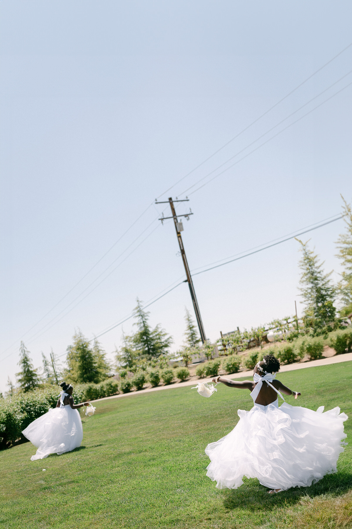 Flower girls playing in field in Serendipity Gardens in Southern California.