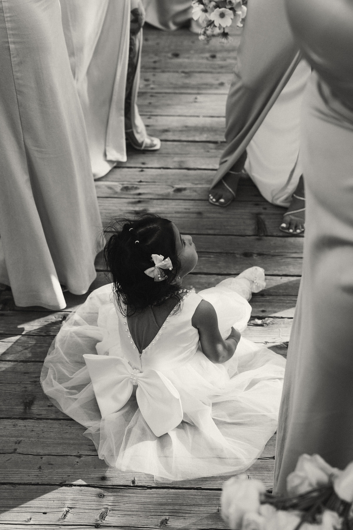 Flower girl having a rest at Serendipity Gardens wedding.