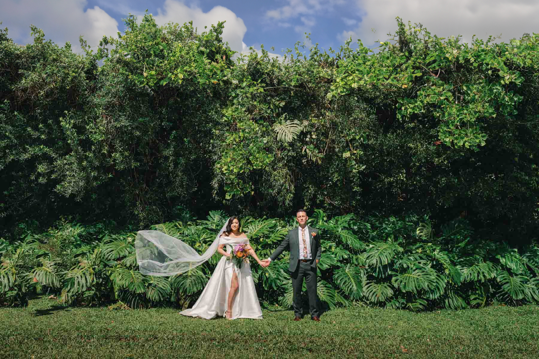 Bride and groom pose at a wedding at Sunset Ranch Oahu.