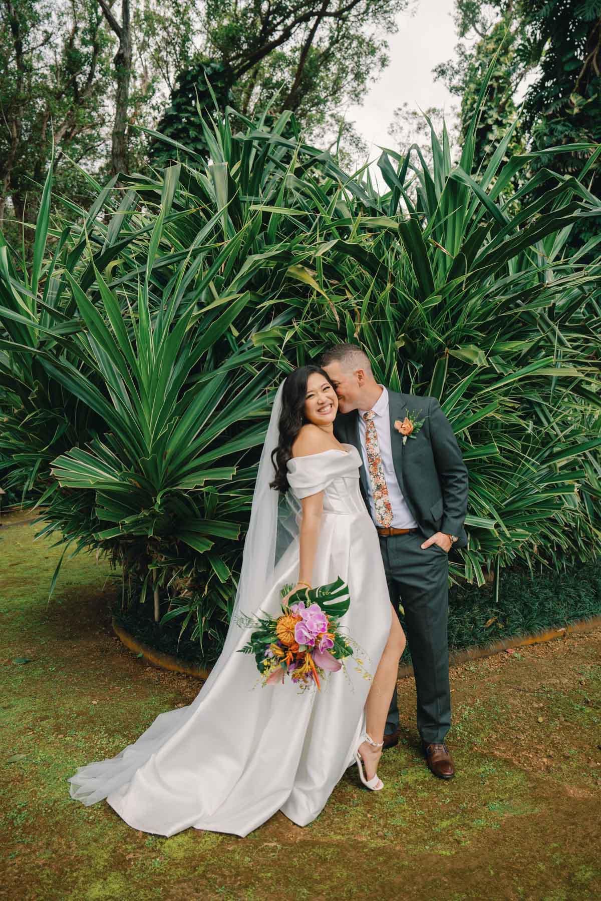 Bride and groom pose at a wedding at Sunset Ranch Oahu.