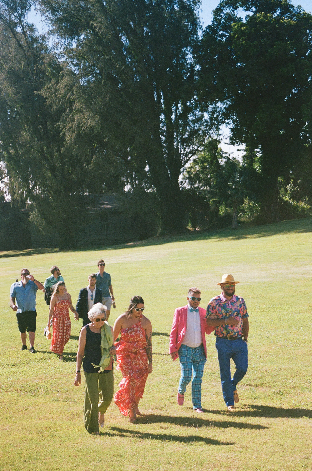 Guests in colorful outfits at a Maui wedding.