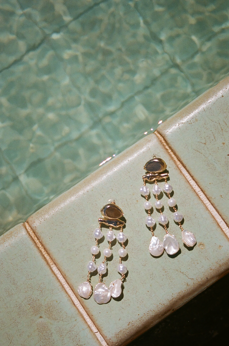 Pearl wedding earrings by the pool.