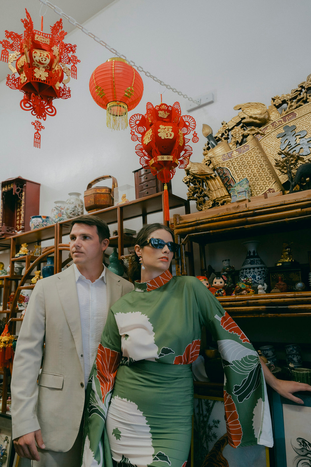 A stylish couple walks the streets of downtown Honolulu during their Oahu couples photo session.