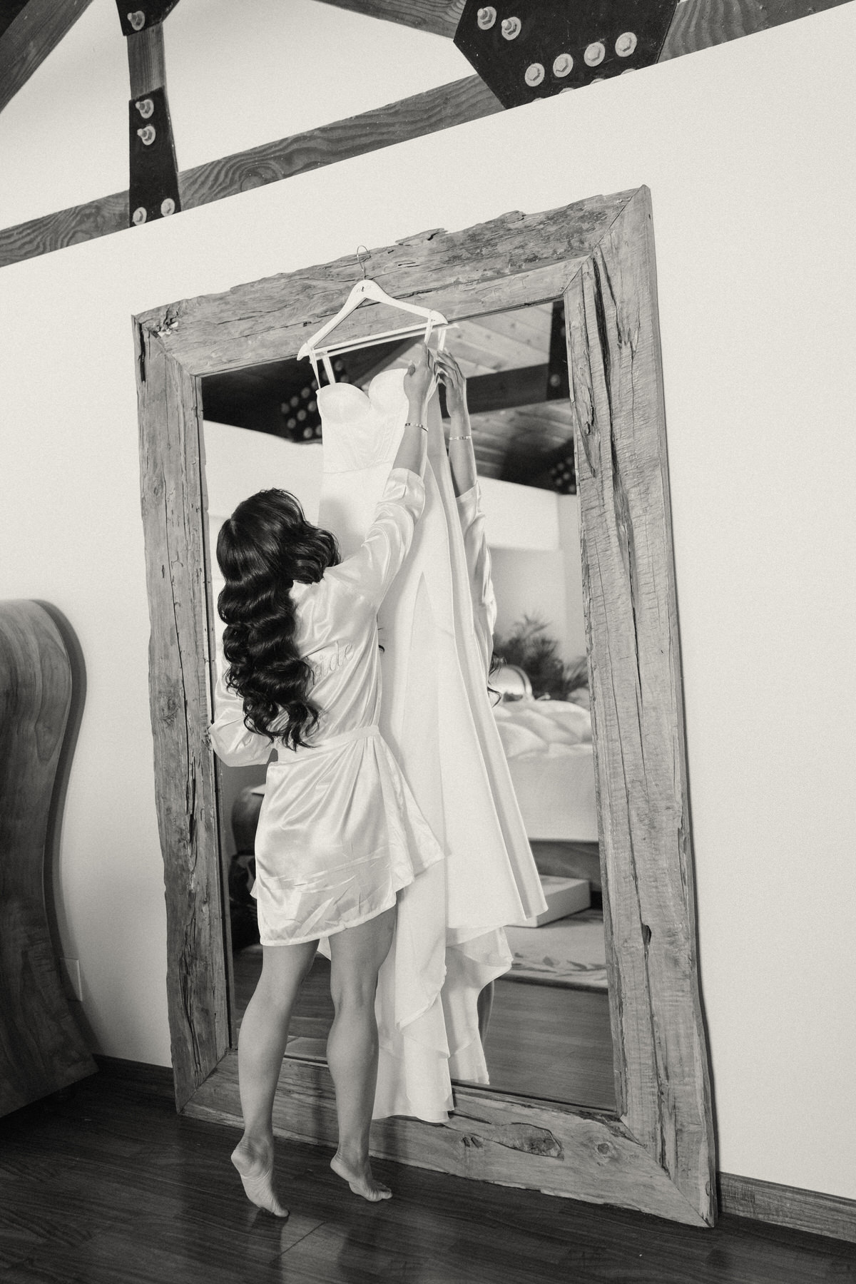 A bride reaching for her wedding dress before the ceremony.