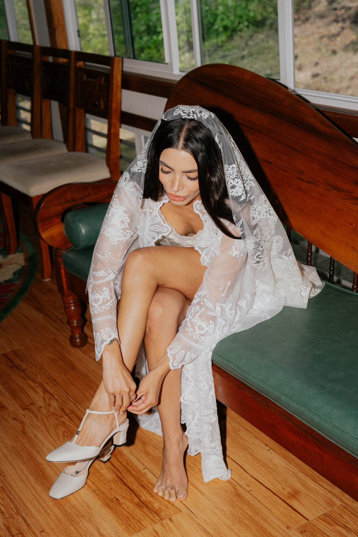 Bride putting her Gucci wedding shoes.