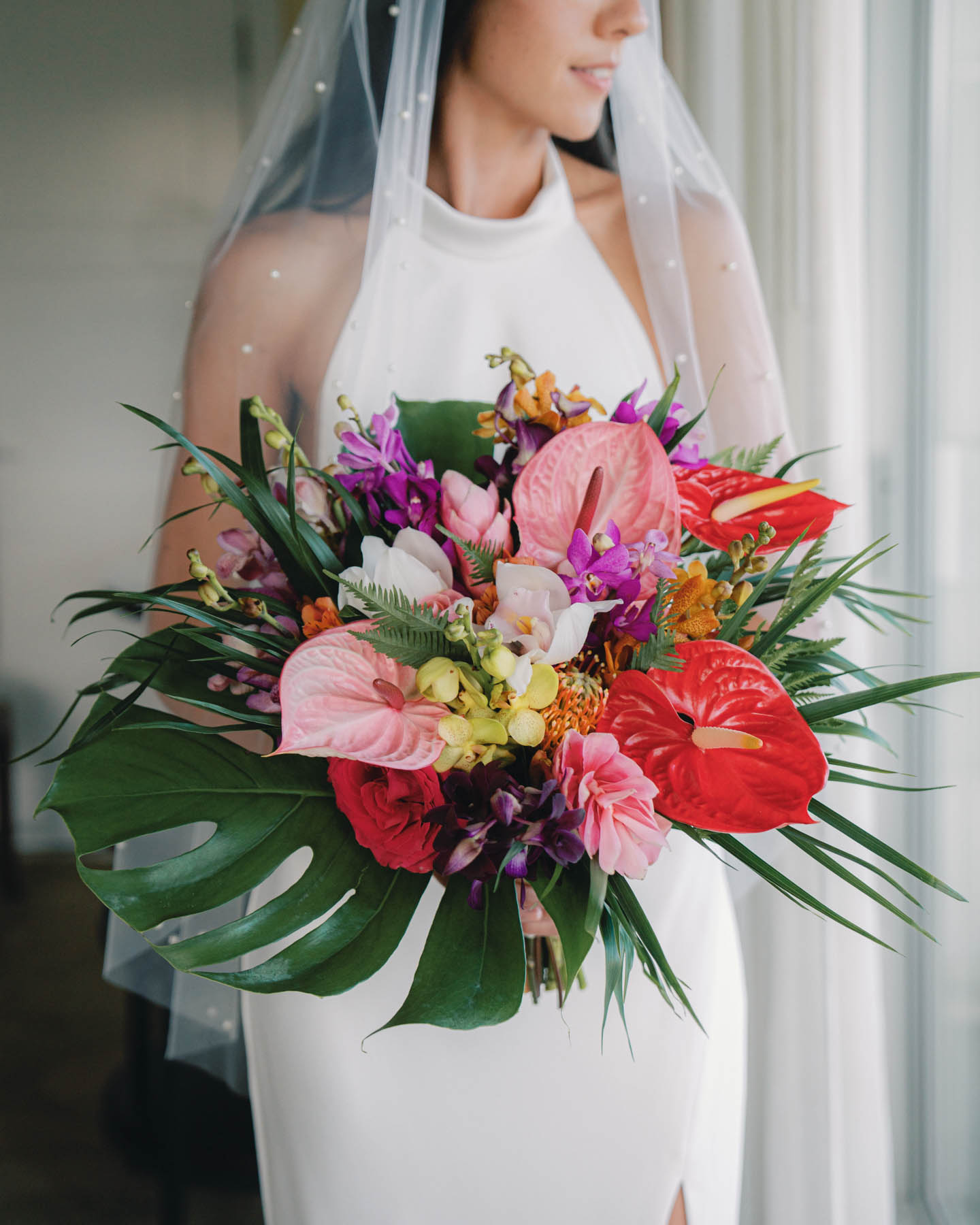 One of the best Oahu wedding florists creates stunning tropical bouquet.