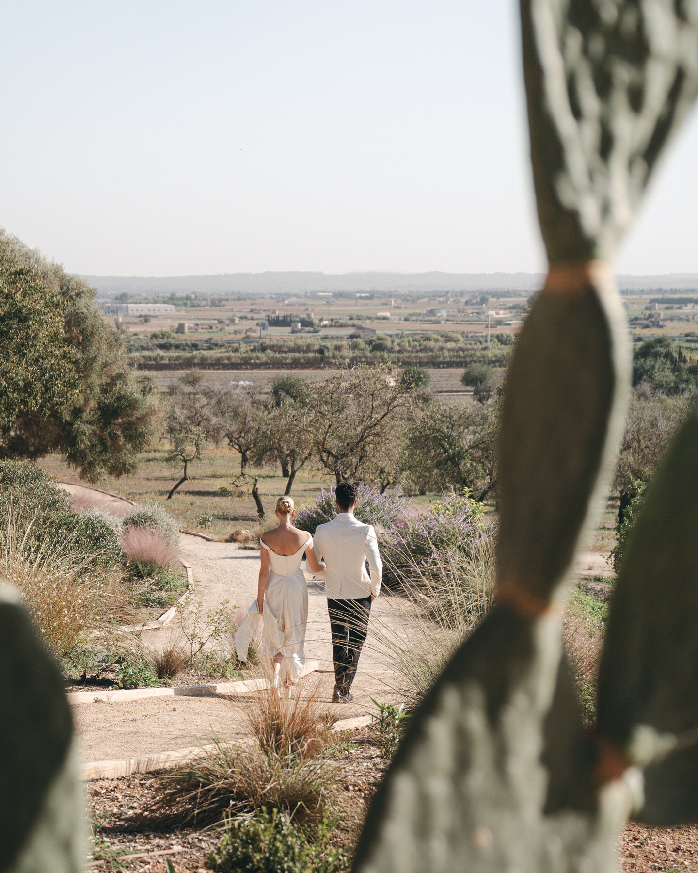 A couple takes a stroll after wedding ceremony in Mallorca.