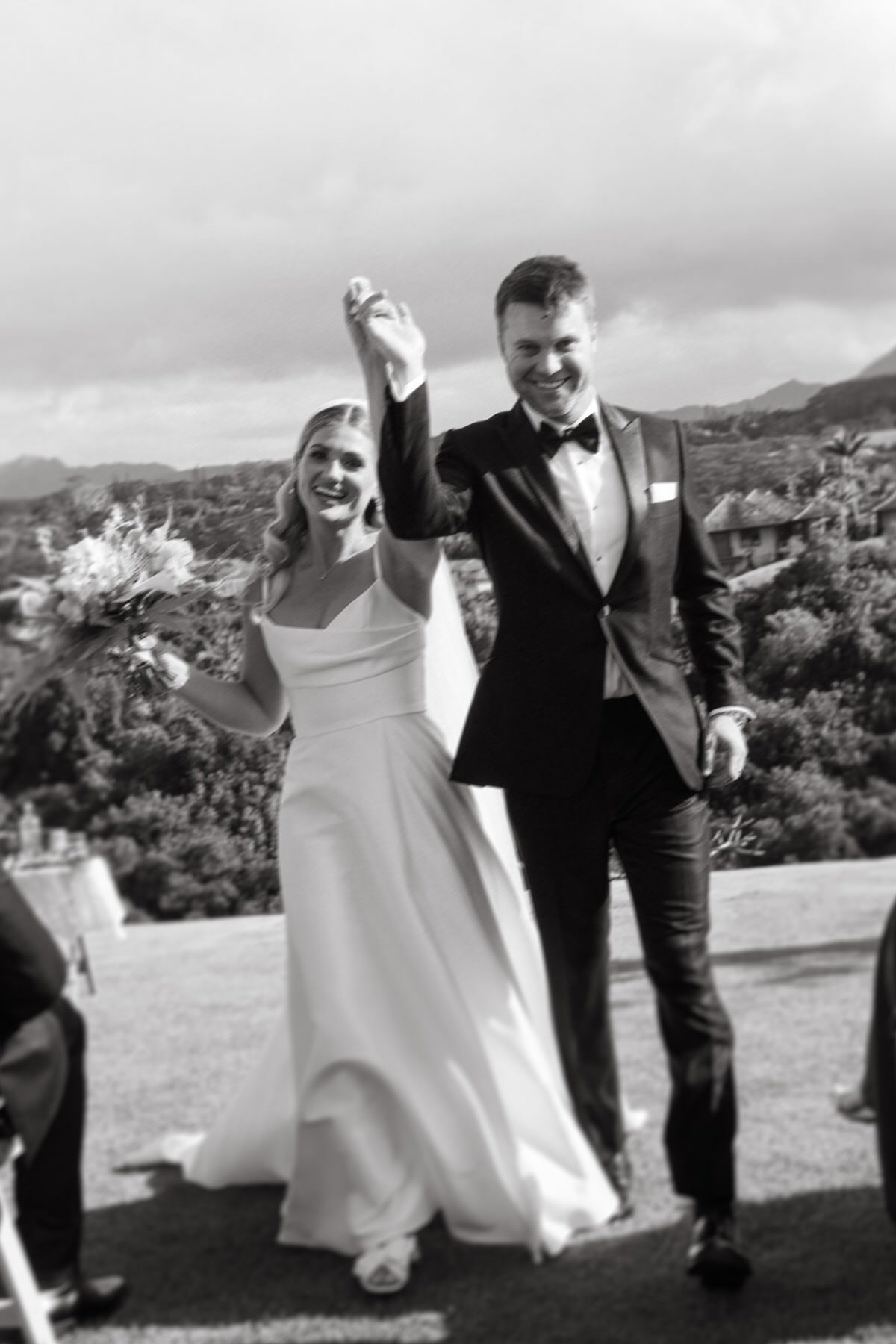 Newlyweds walk hand-in-hand down the aisle, beaming with joy, set against Hawaii’s stunning landscape—an iconic shot in any Destination Wedding Photography Guide for Couples Planning a Hawaii Wedding.