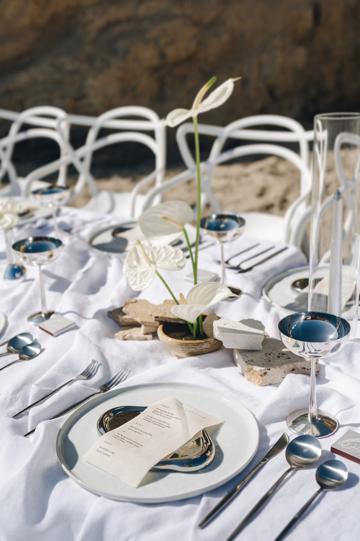 Stylish wedding table setup on the beach with delicate floral arrangements, captured in Elopement Photography in Hawaii.