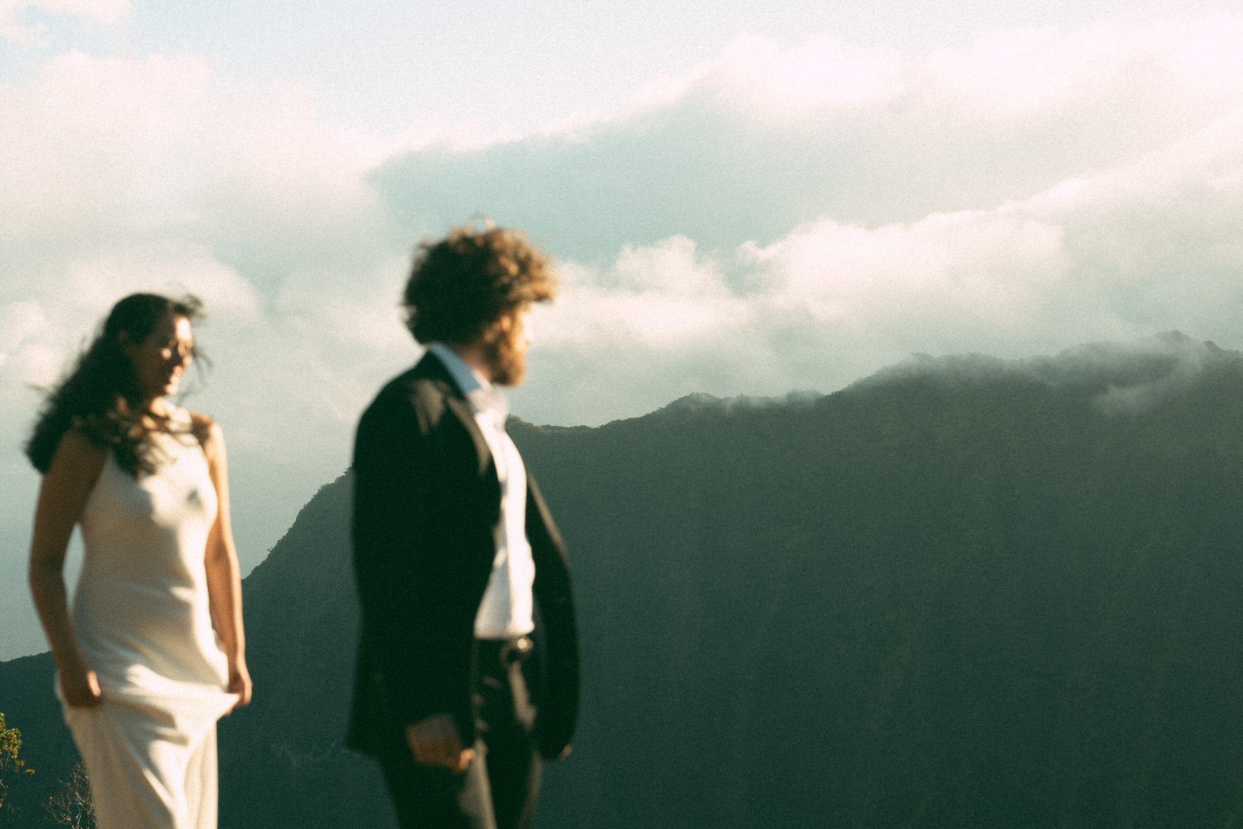 Groom looking out over the mountains, creating a breathtaking backdrop for his elopement, captured in Elopement Photography in Hawaii.