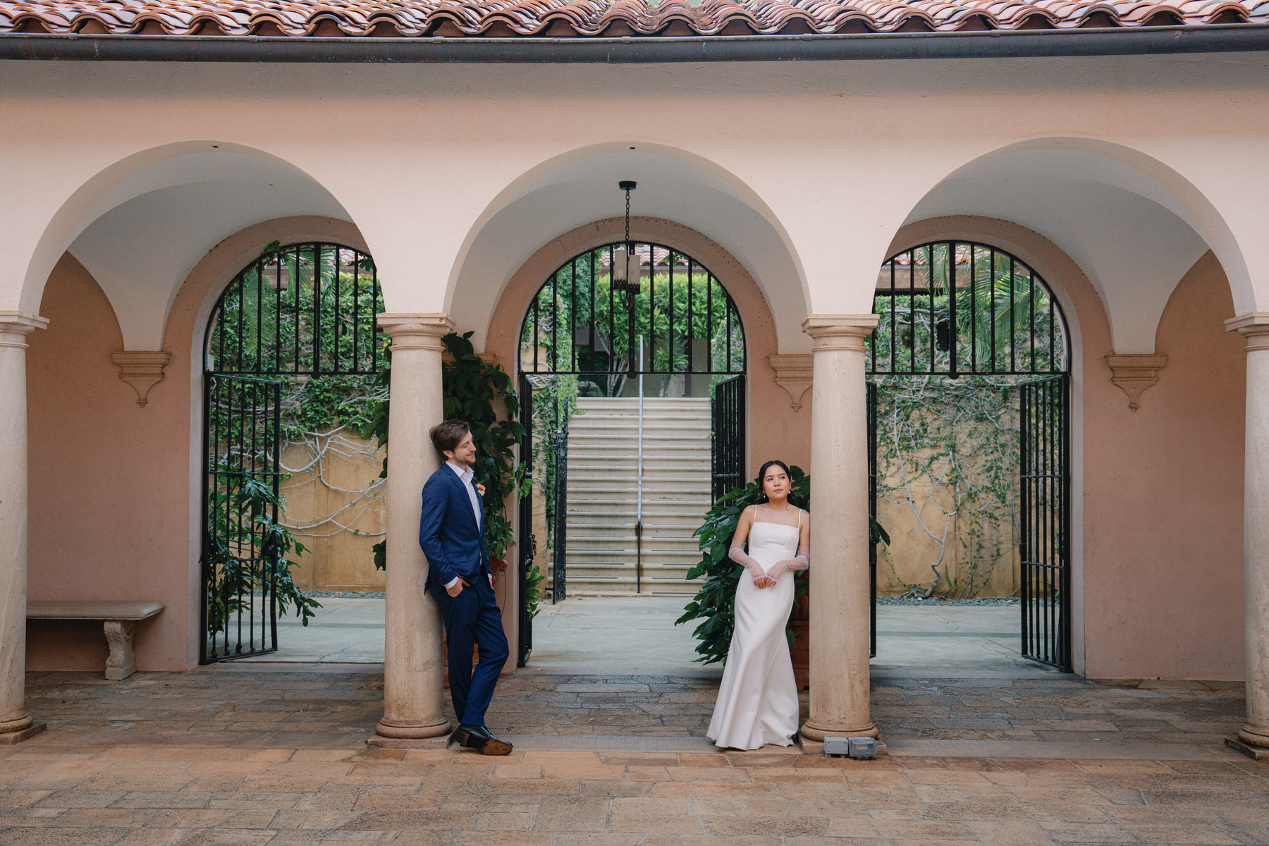 A romantic moment between bride and groom framed by Tuscan-style arches at La Pietra, embodying architectural elegance in La Pietra Wedding: A Guide for Modern Couples.