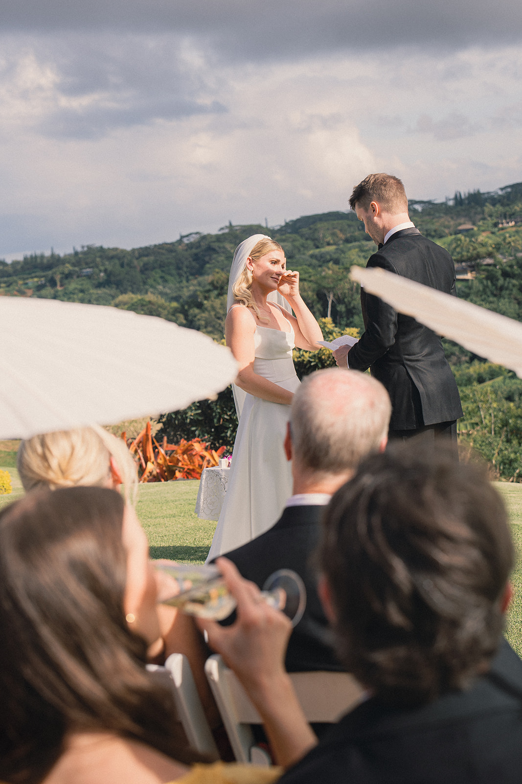 Bride smiling with tears of joy while exchanging vows during a marriage proposal session, captured in Marriage Proposal Photo Session in Oahu.