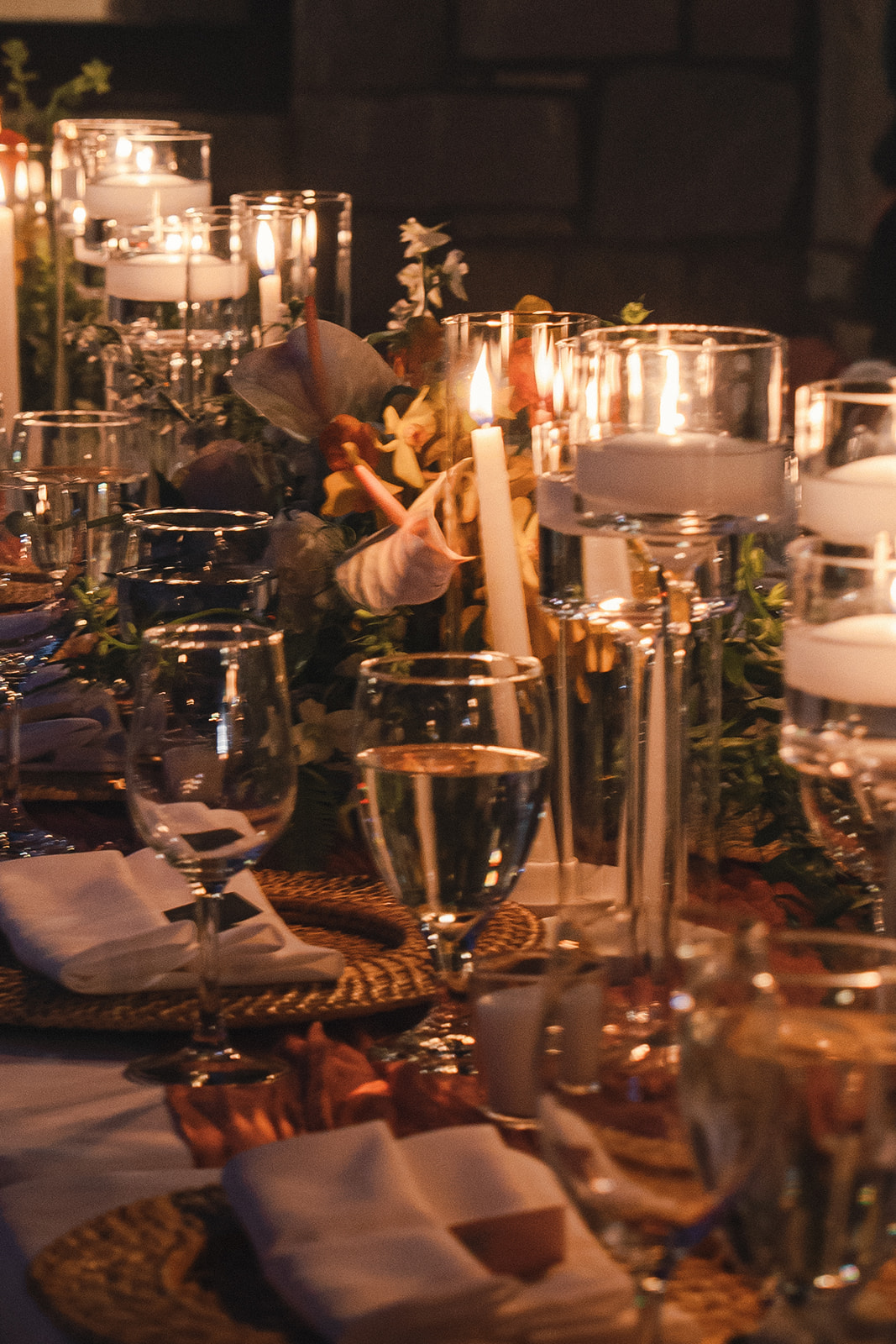Romantic evening shot of the reception table set with candles and glasses, creating an elegant atmosphere in Elopement Photography in Hawaii.
