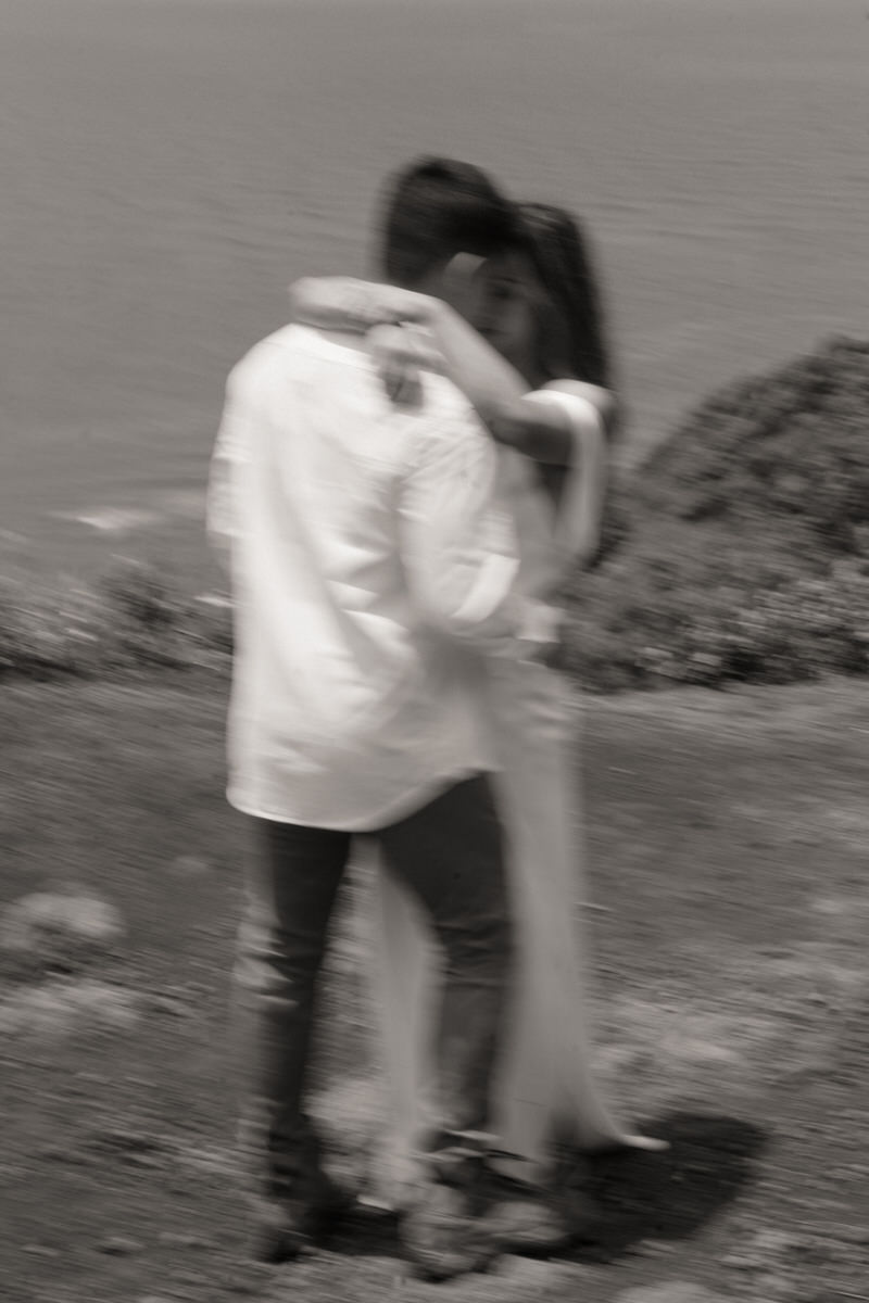 A slightly blurred yet emotional moment of a couple embracing during their proposal shoot, captured in Marriage Proposal Photo Session in Oahu.