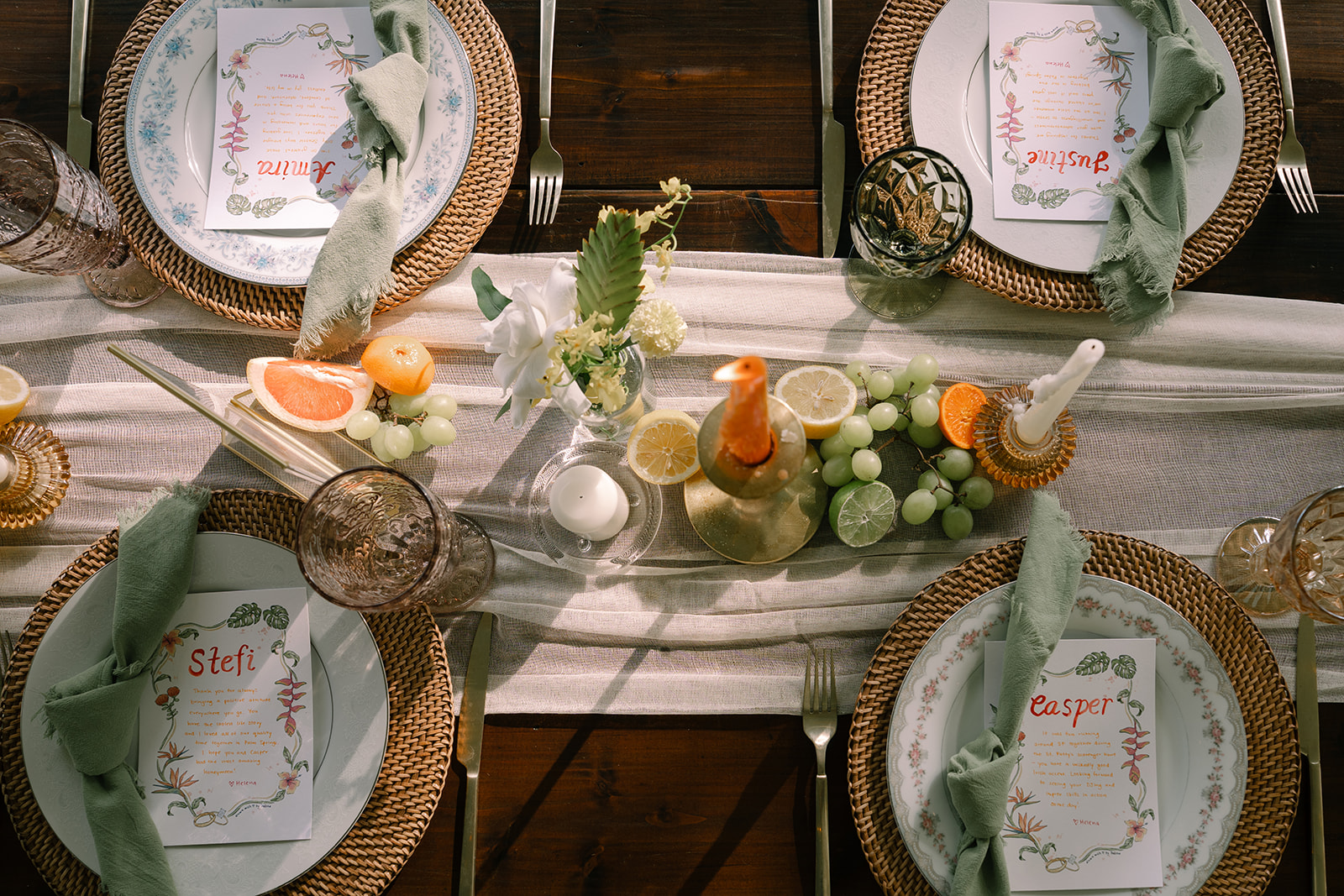 Overhead view of styled outdoor reception table with woven chargers, glassware, and citrus centerpiece – How to Choose the Right Photographer for Your Pre-Wedding Shoot