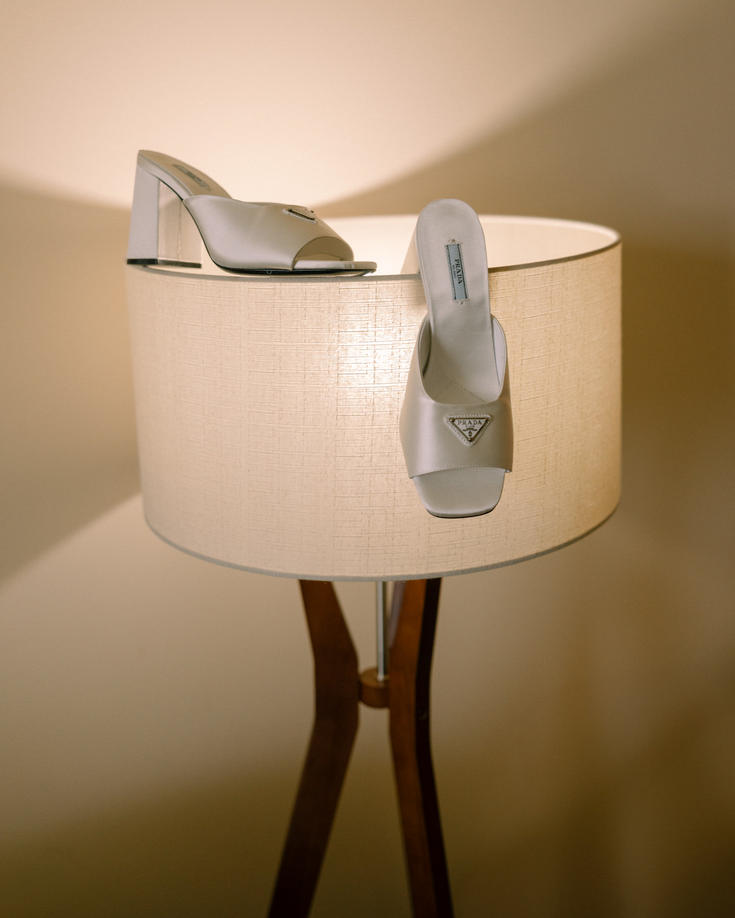 Bridal shoes on a lamp at Kualoa Ranch, Paliku Gardens, highlighting the details of the bride's attire.