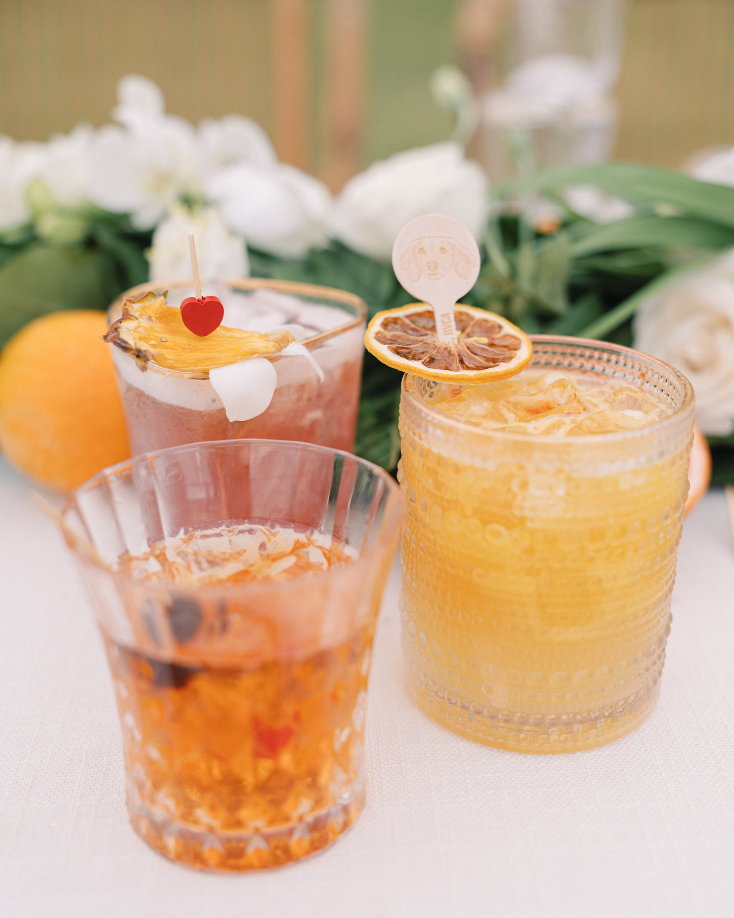 Signature cocktails with vibrant garnishes displayed at a wedding reception at Kualoa Ranch, Paliku Gardens in Oahu