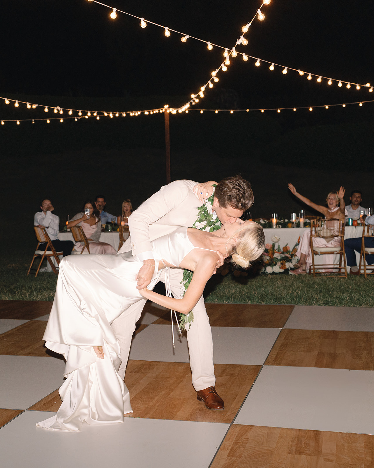 First dance of the bride and groom under twinkling string lights at Kualoa Ranch, Paliku Gardens, Oahu.