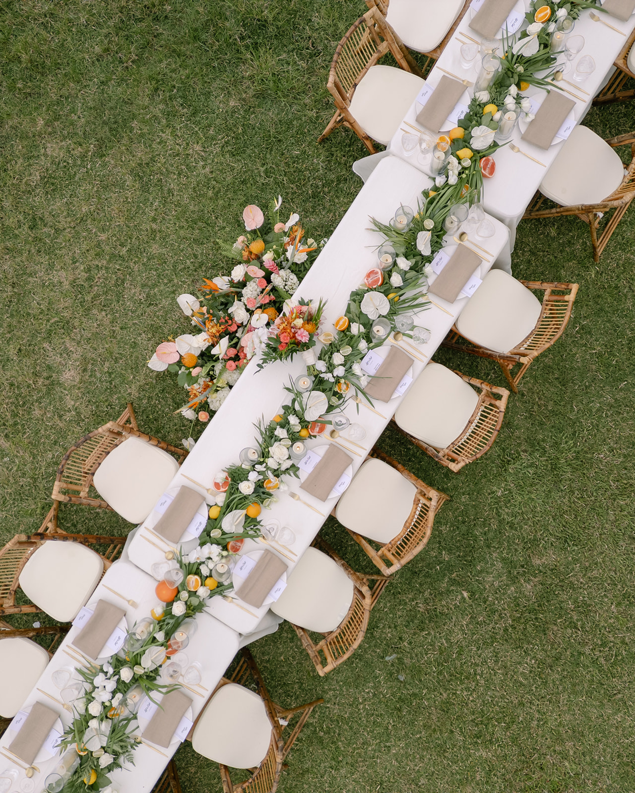 Aerial view of the elegant reception tables decorated with floral arrangements at Kualoa Ranch, Paliku Gardens, Oahu.