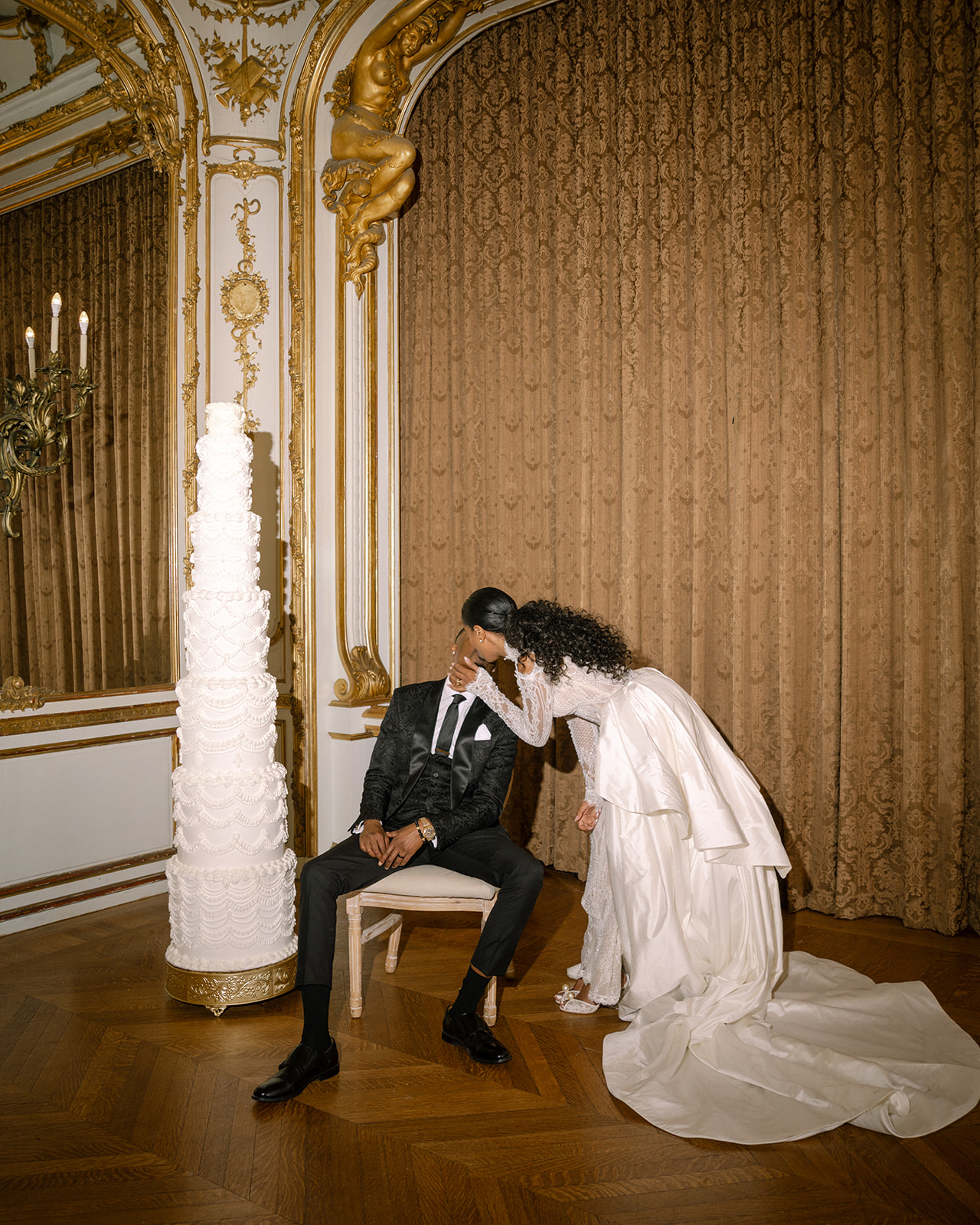 Intimate moment between the newlywed couple during their first dance, surrounded by luxurious decor at their brunch wedding at Ochre Court Newport.