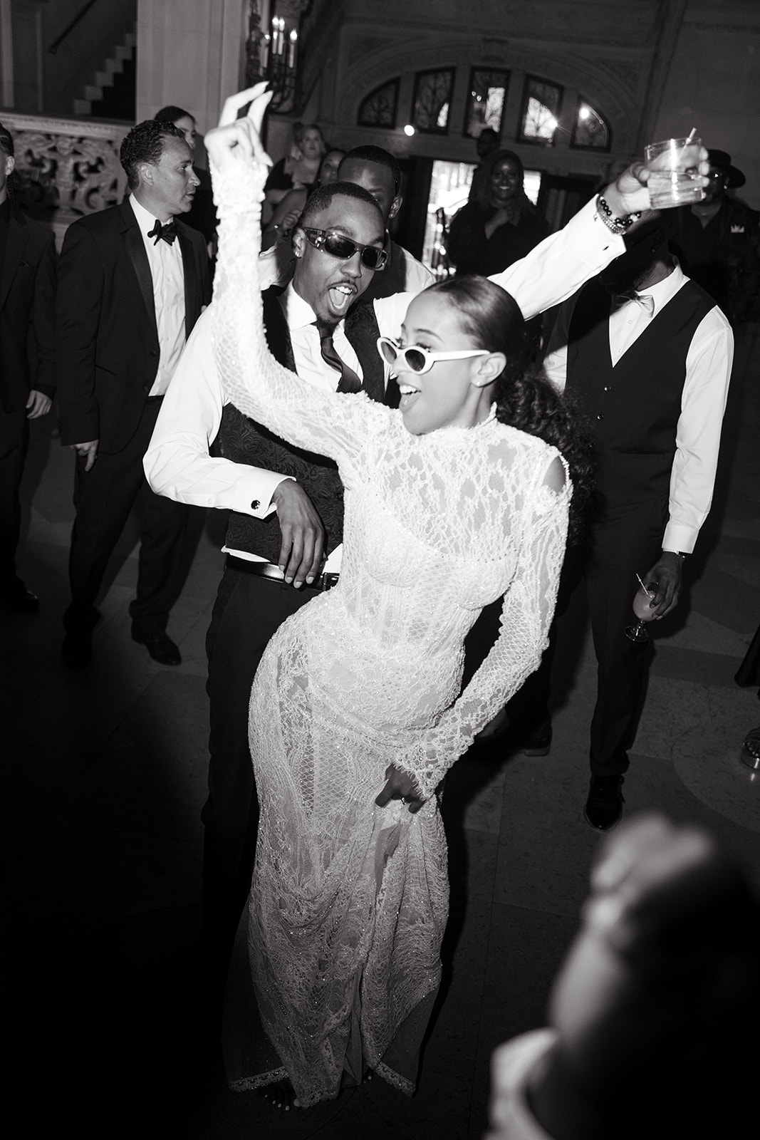 Bride and groom dancing joyfully at the reception, surrounded by guests at their Brunch Wedding at Ochre Court Newport.
