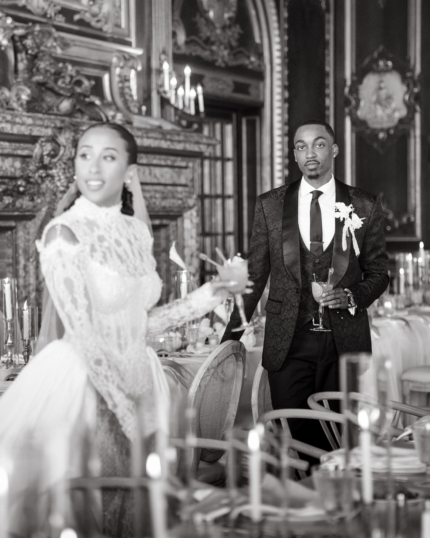 Bride and groom sharing a toast at their elegant reception, captured in a moment of joy during their wedding celebration.