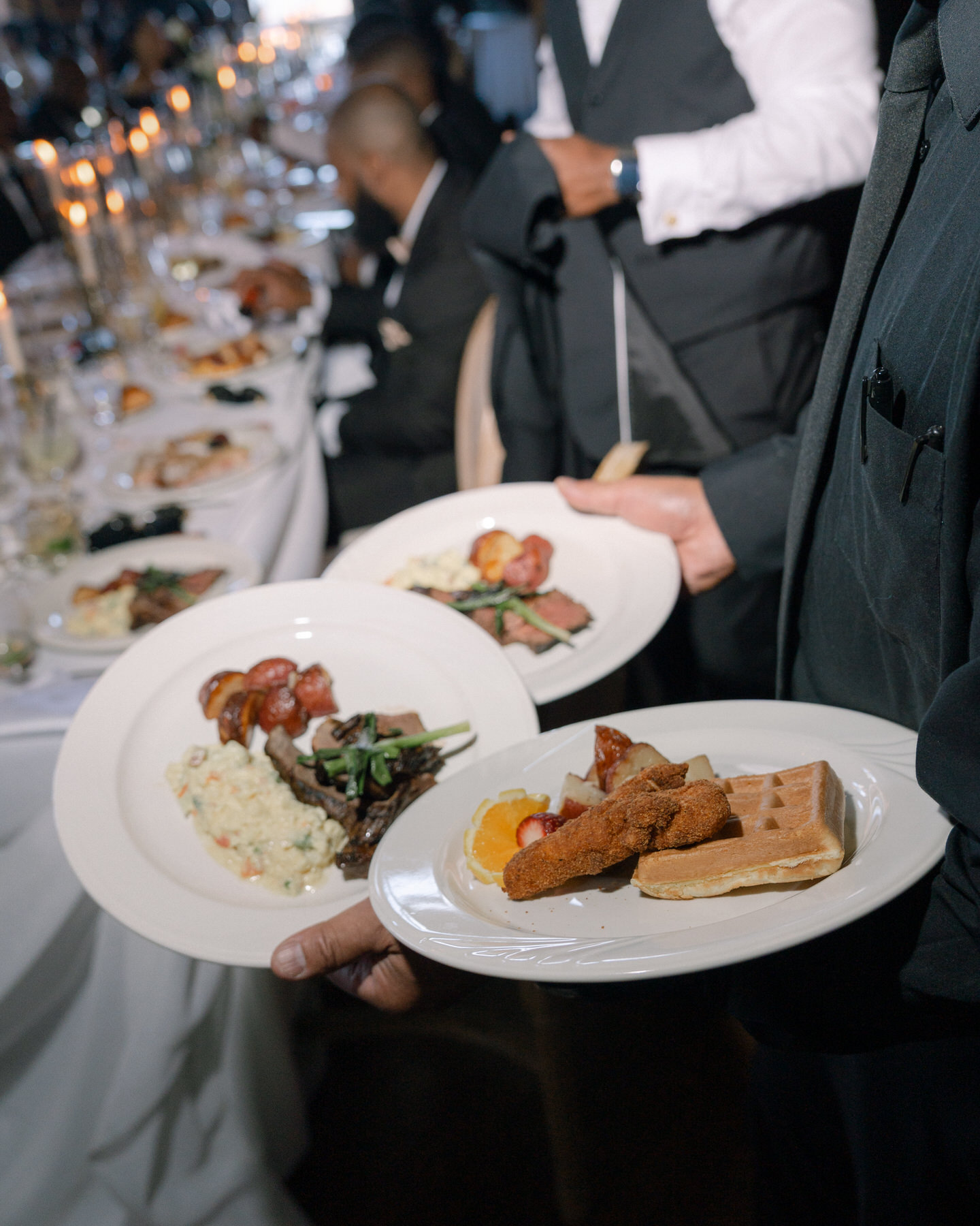 Waitstaff serving delicious dishes during the brunch wedding reception at Ochre Court Newport, offering a variety of gourmet plates to the guests.