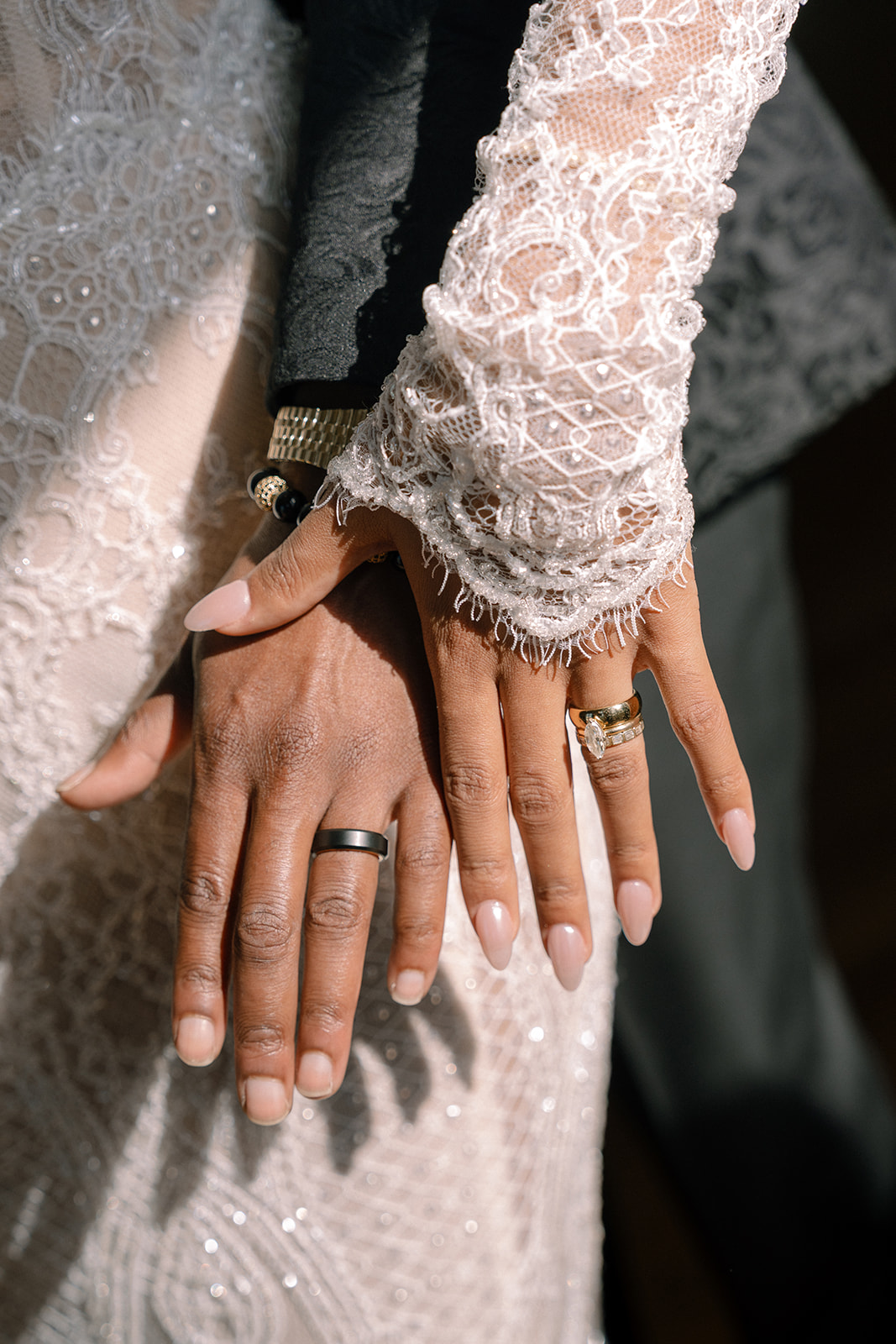 Close-up of the bride and groom's hands, showcasing their wedding rings during the brunch wedding at Ochre Court Newport.