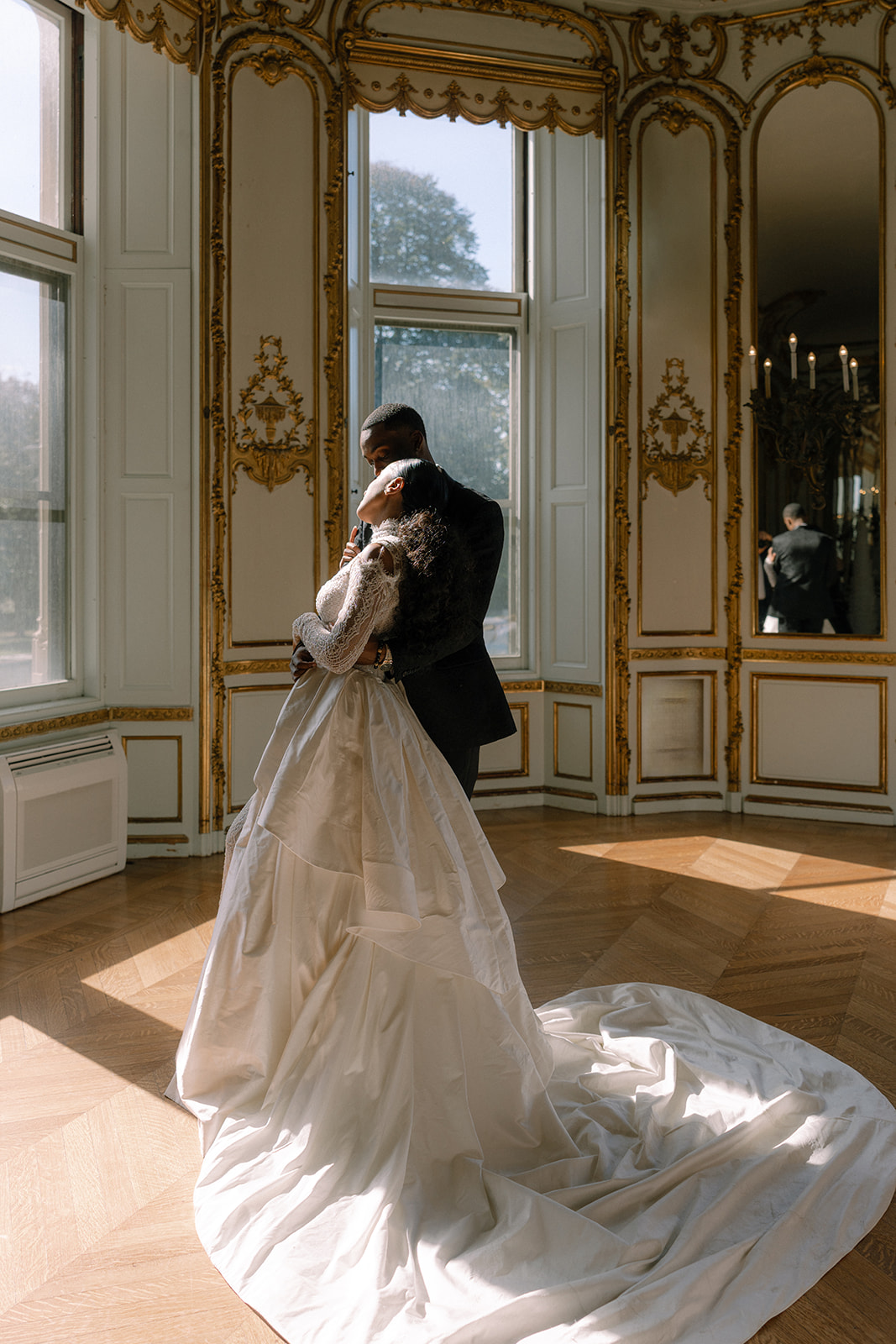 Couple sharing an intimate moment, dancing in the sunlit room, during their Brunch Wedding at Ochre Court Newport
