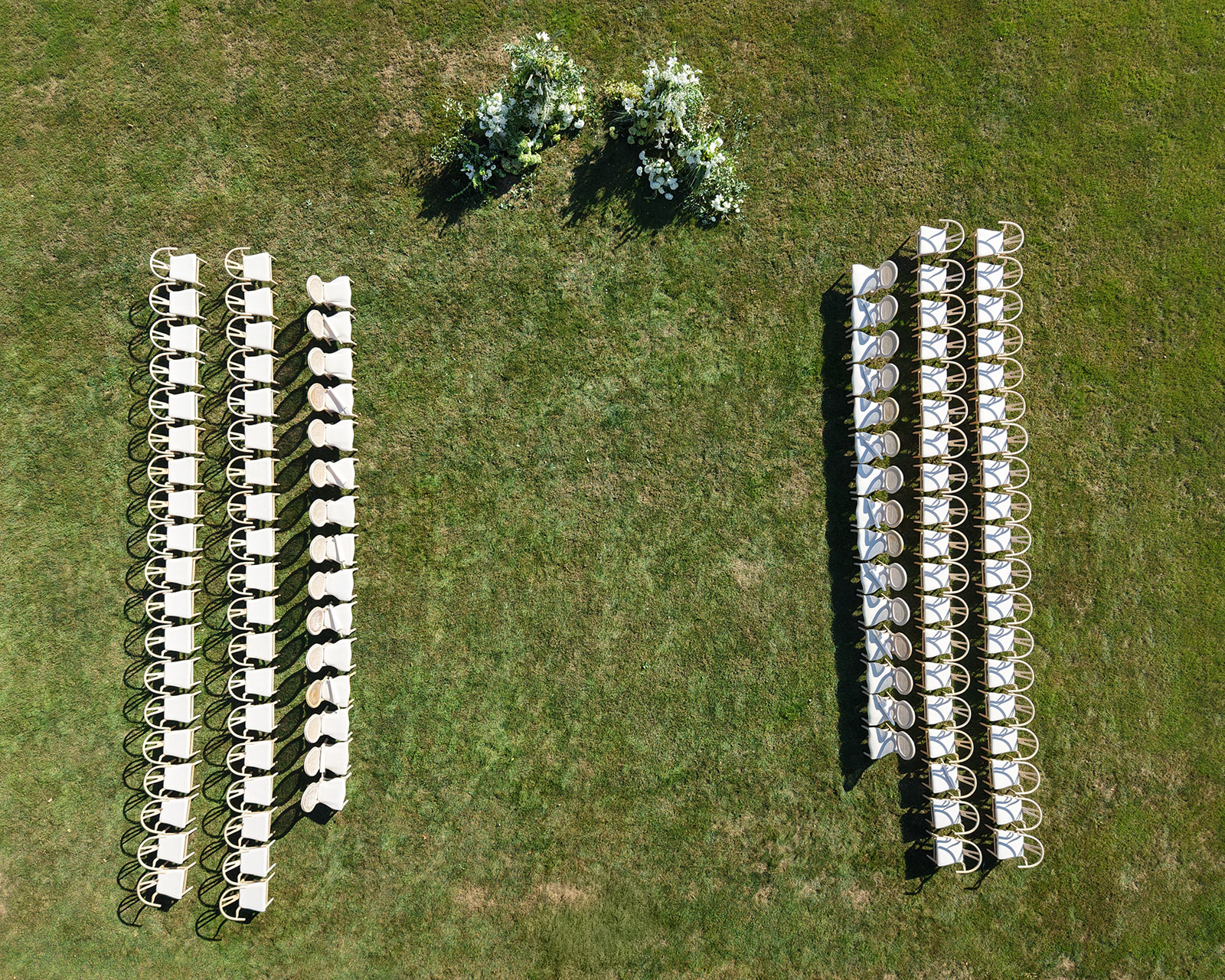 Aerial view of the ceremony setup for a Brunch Wedding at Ochre Court Newport, with rows of chairs and floral arrangements.