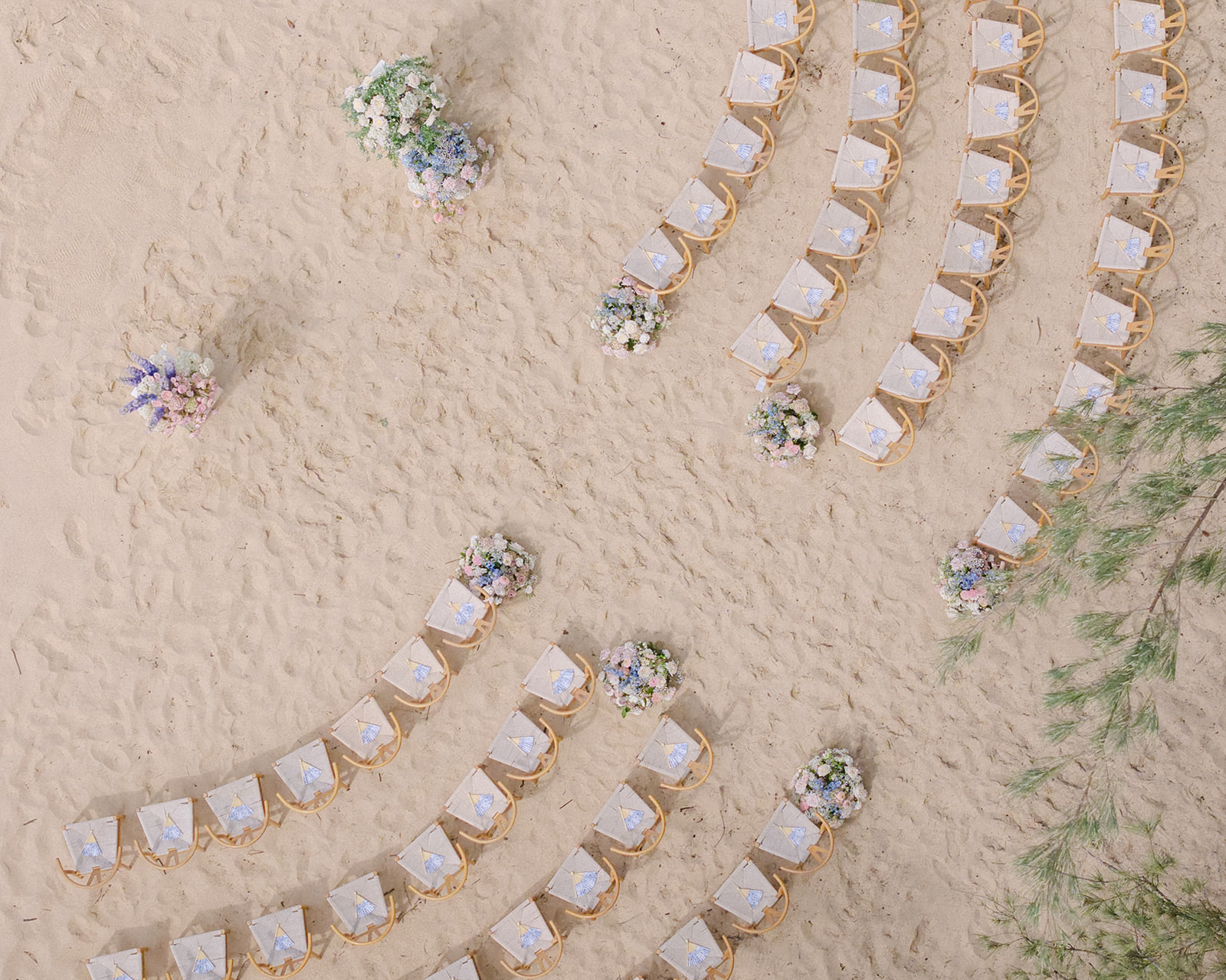 Turtle Bay Oahu wedding ceremony aerial view with chairs and floral arrangements